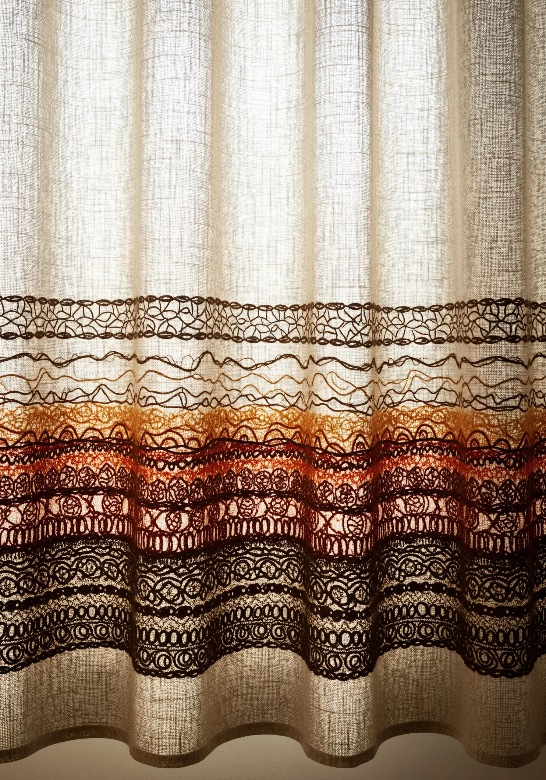 Sheer linen curtain with an intricate, earthy-toned embroidered border at the bottom.