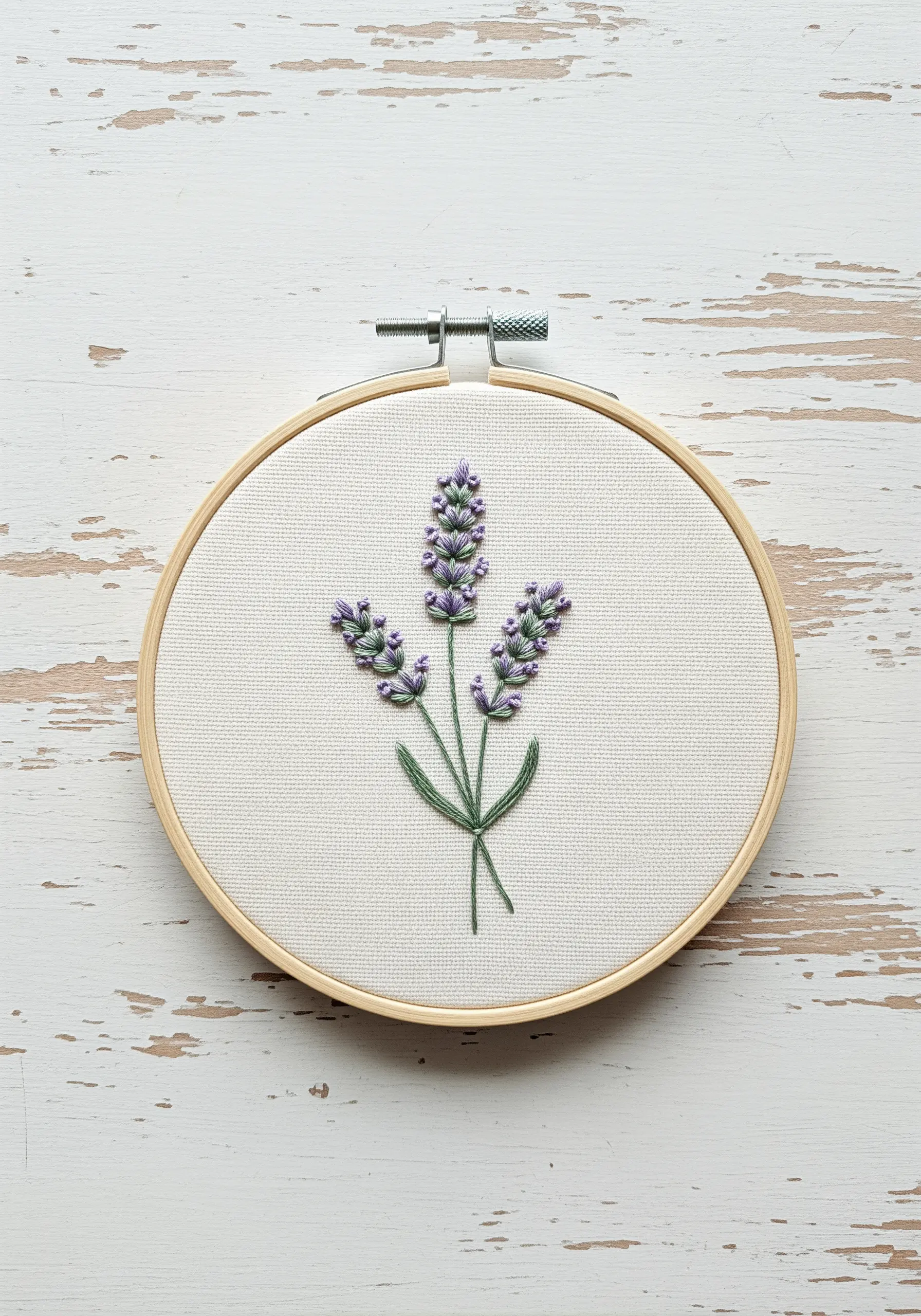 Three lavender sprigs embroidered with purple French knots and green stems on off-white fabric.