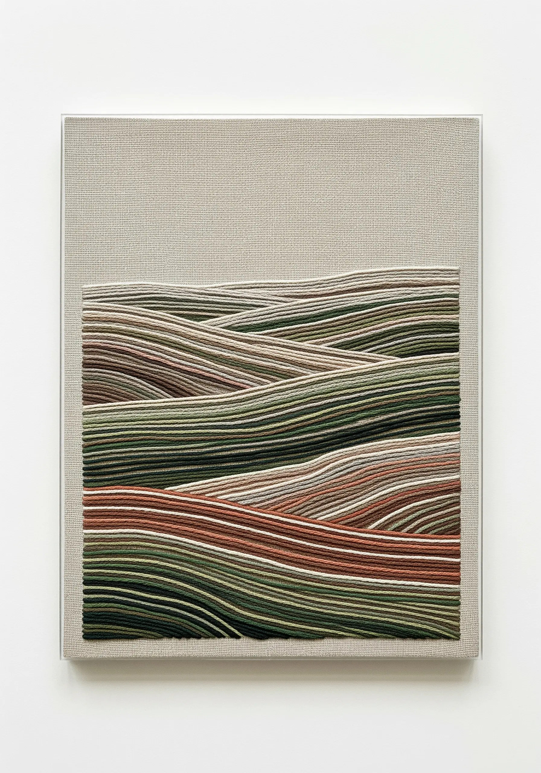 Embroidered landscape of rolling hills on a smaller canvas mounted onto a larger linen-covered canvas.