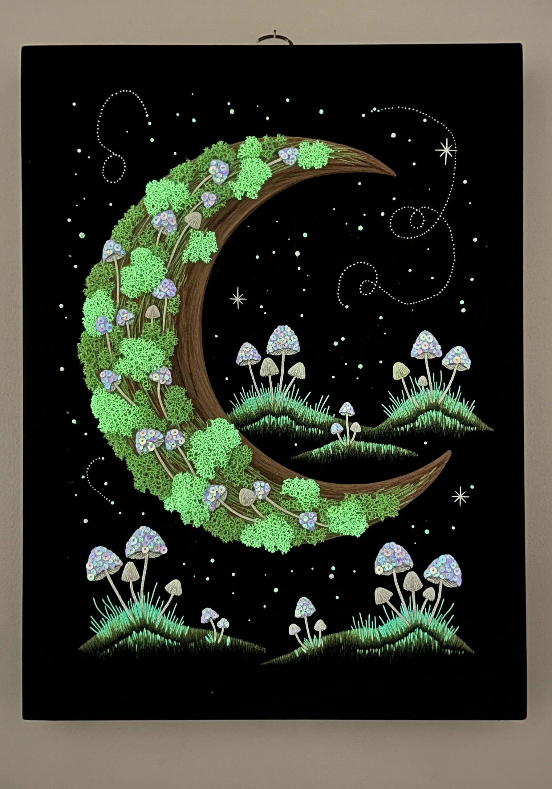 A crescent moon covered in glow-in-the-dark moss and surrounded by glowing mushrooms.