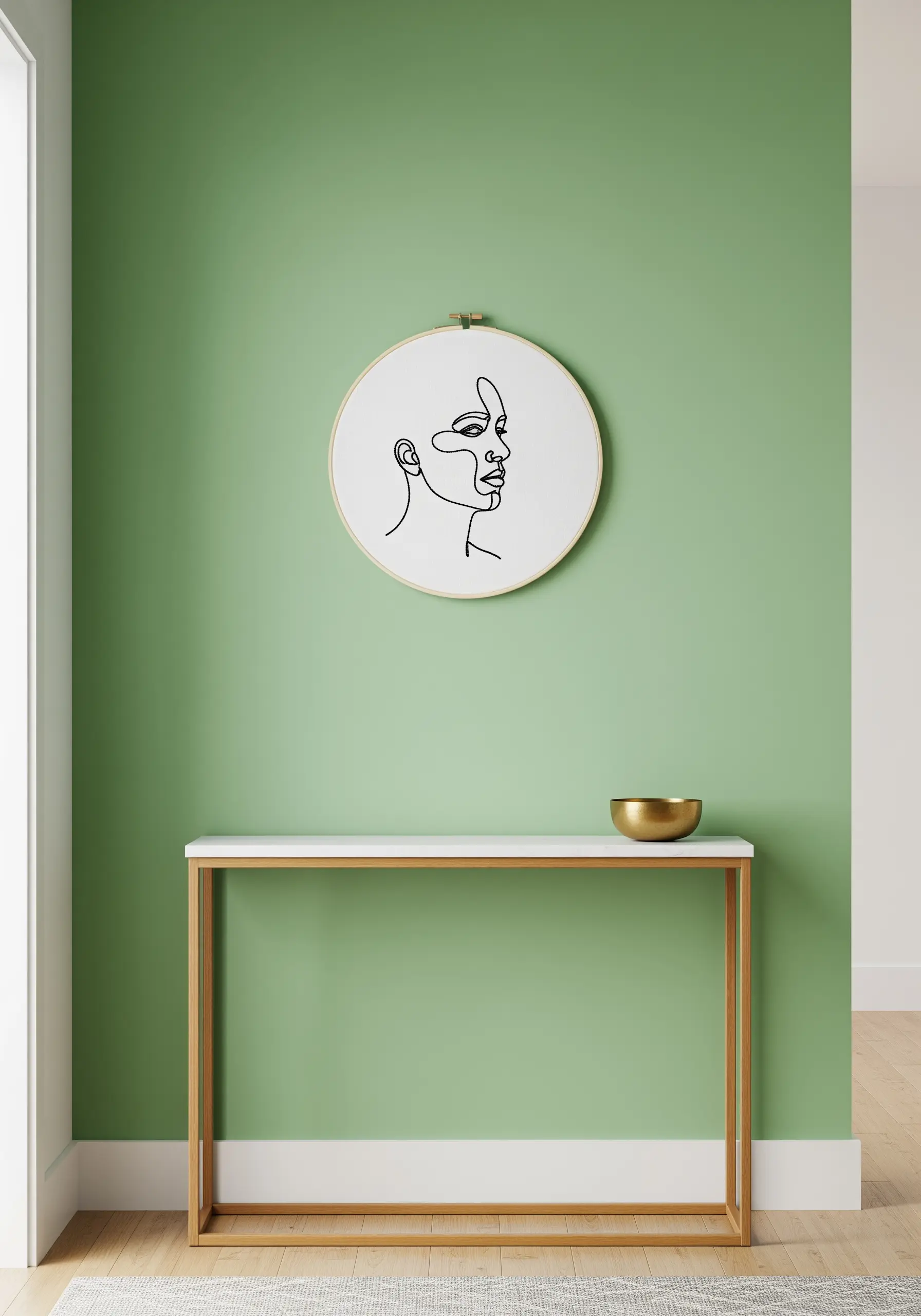 A minimalist line art hoop hanging alone on a bold sage green wall.