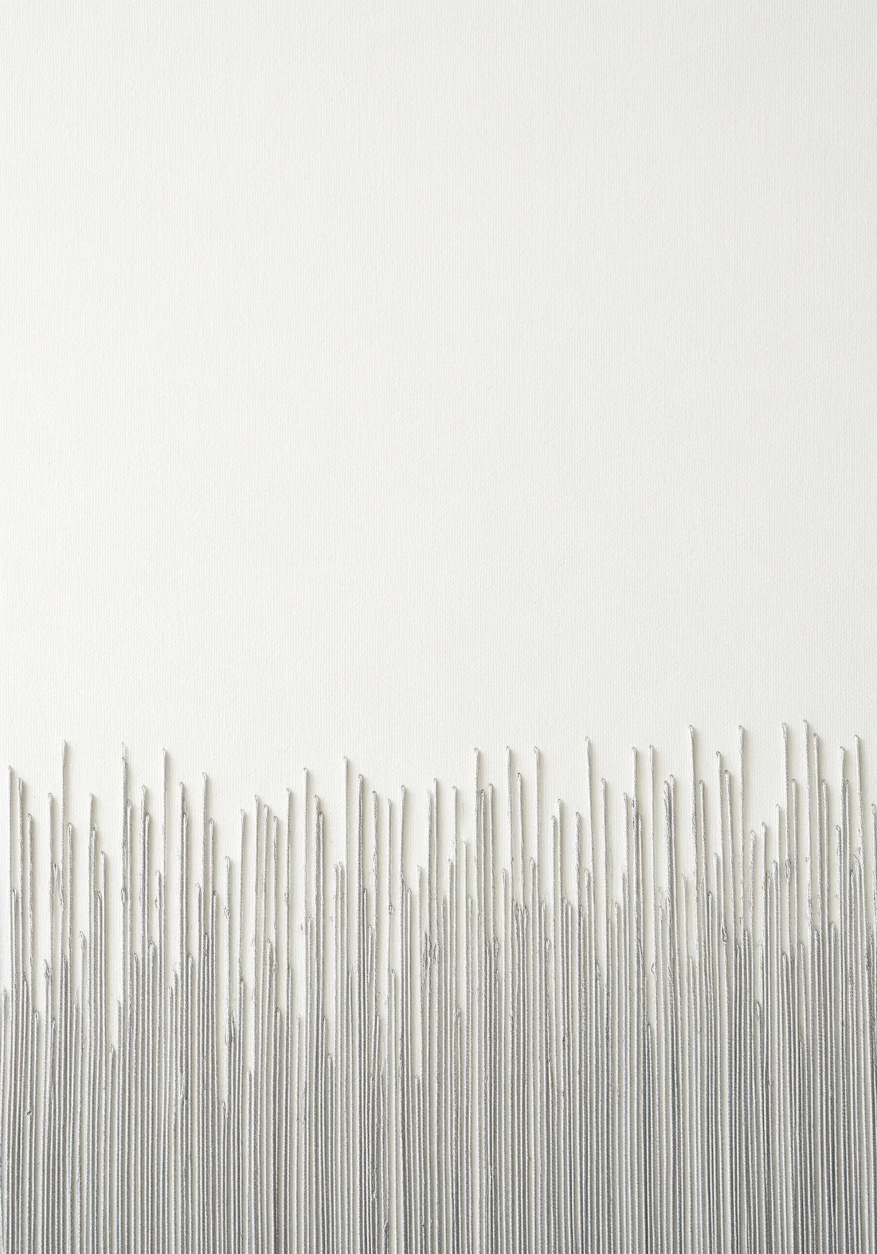 Uneven vertical straight stitches in grey thread creating a textured border on white canvas.