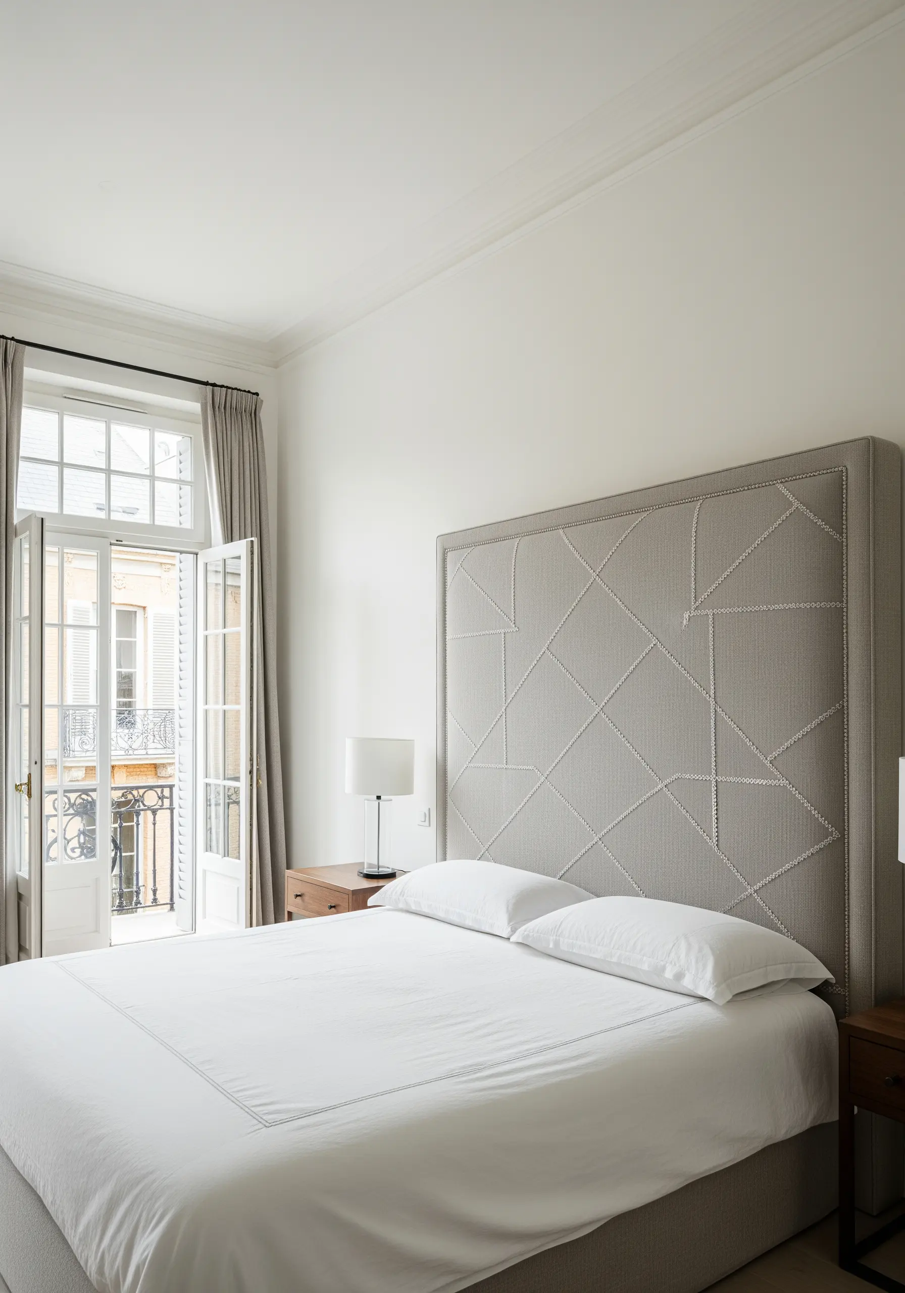 Tone-on-tone seed stitch embroidery creating a geometric pattern on a fabric headboard.