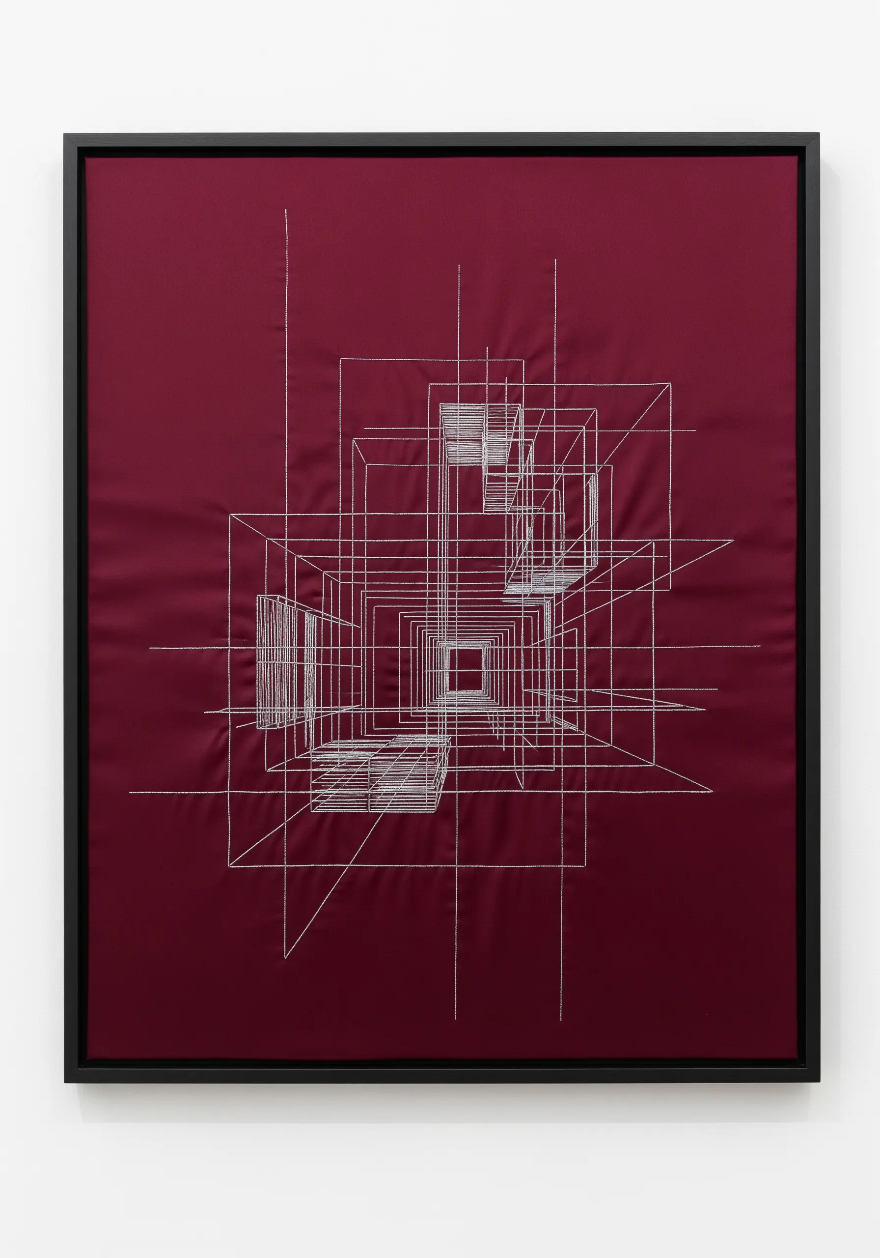 Abstract architectural line art in white thread on a deep red fabric.