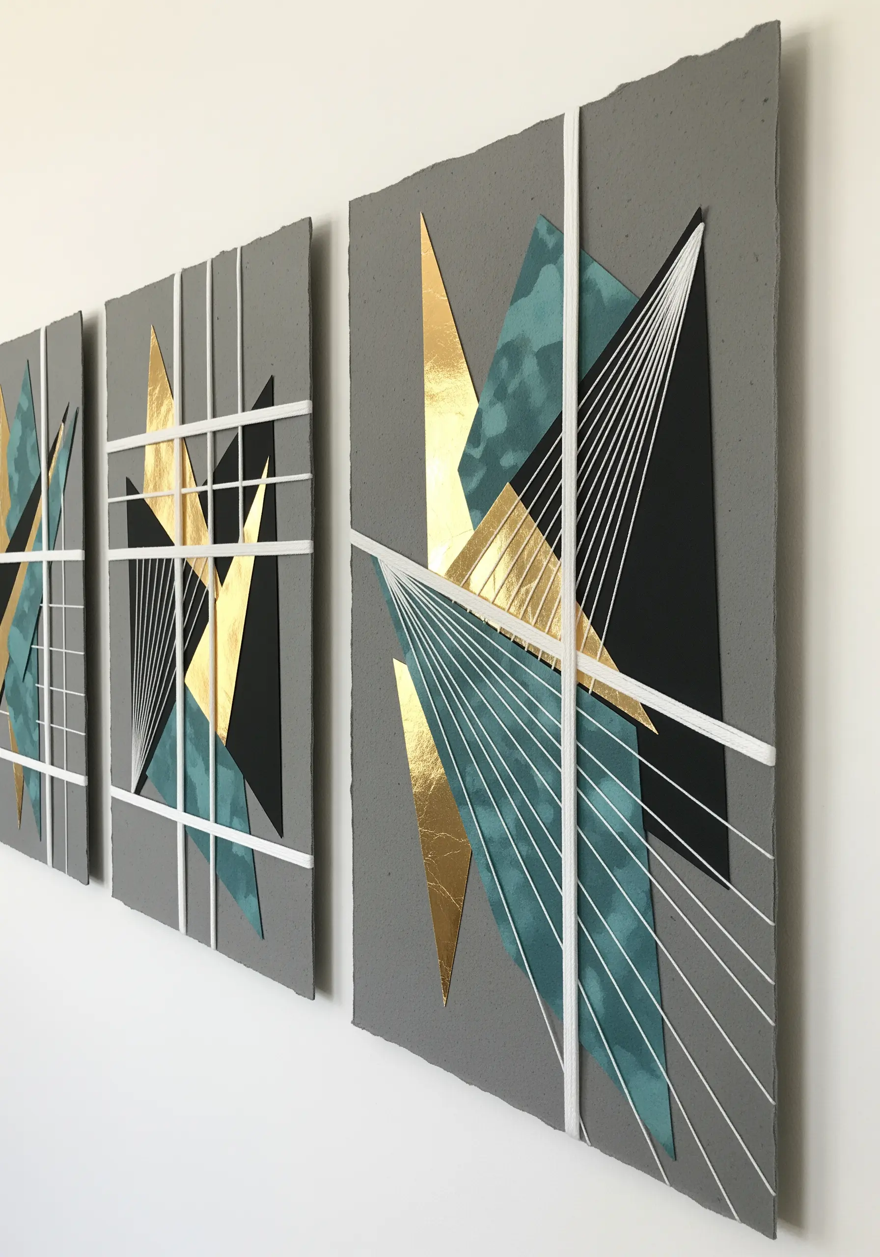 Geometric string art with gold foil and teal paper on grey panels.