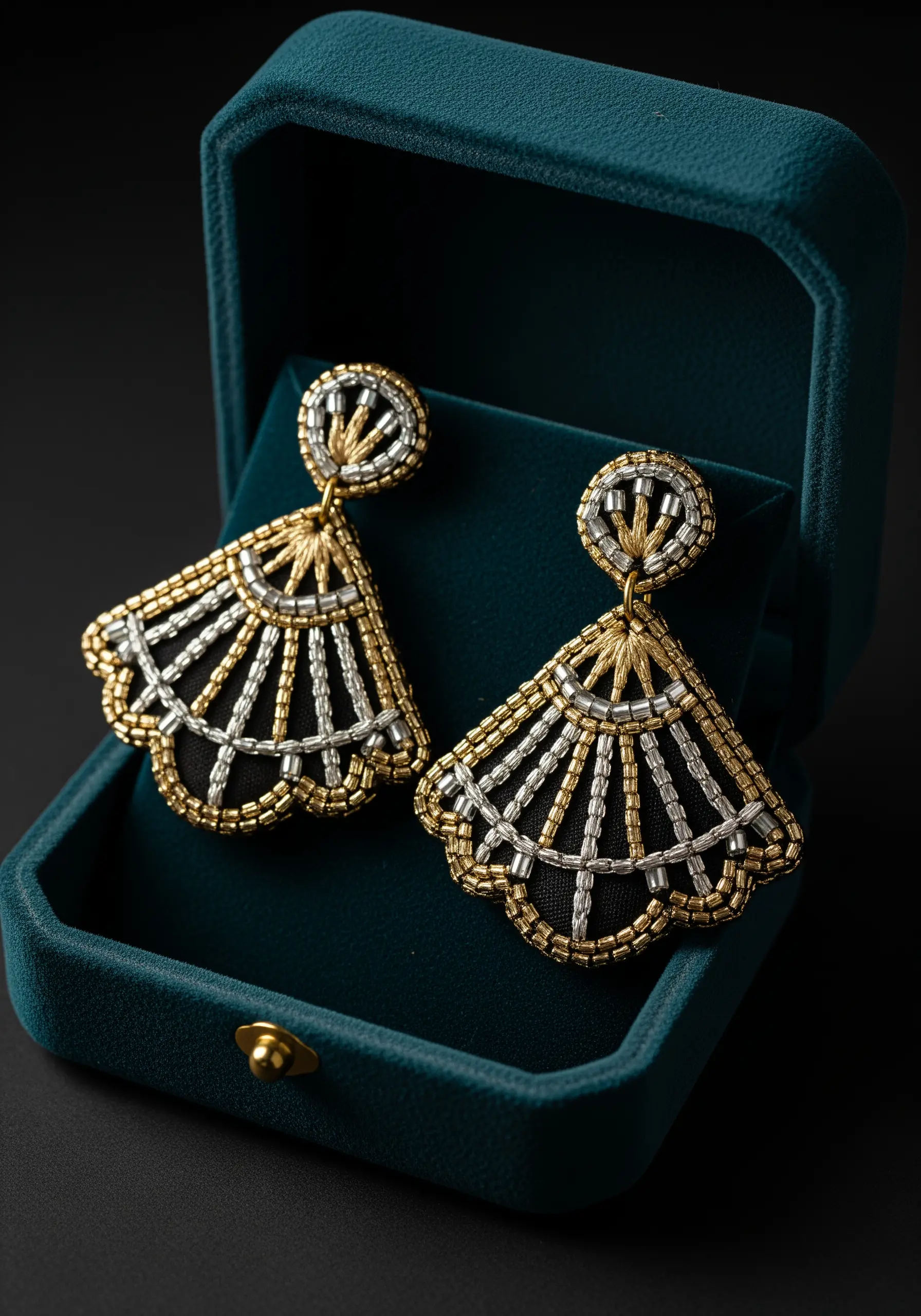 Art Deco style fan earrings with gold metallic thread and silver and gold seed beads on black fabric.