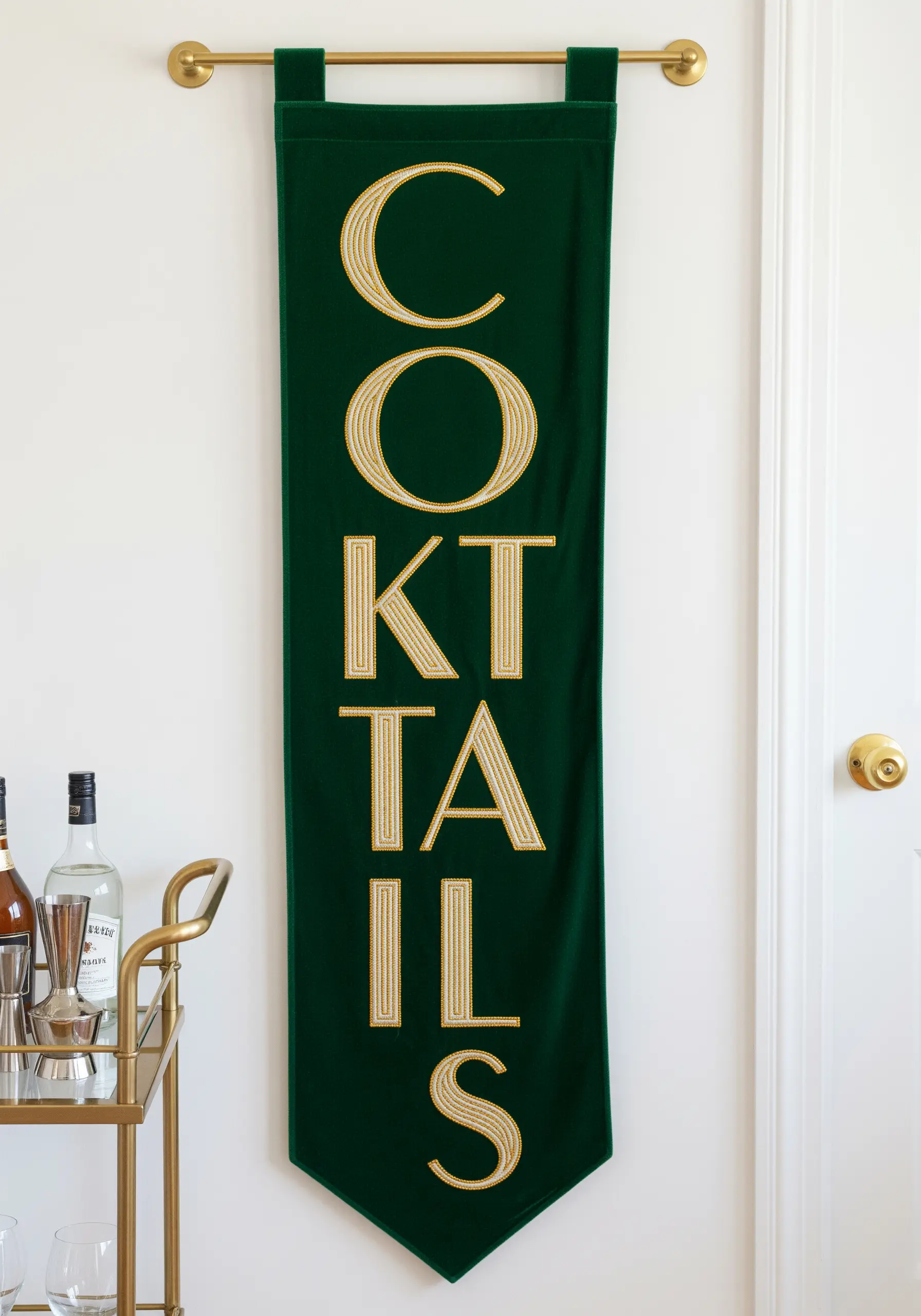 Art deco style lettering in gold thread on a dark green velvet banner.