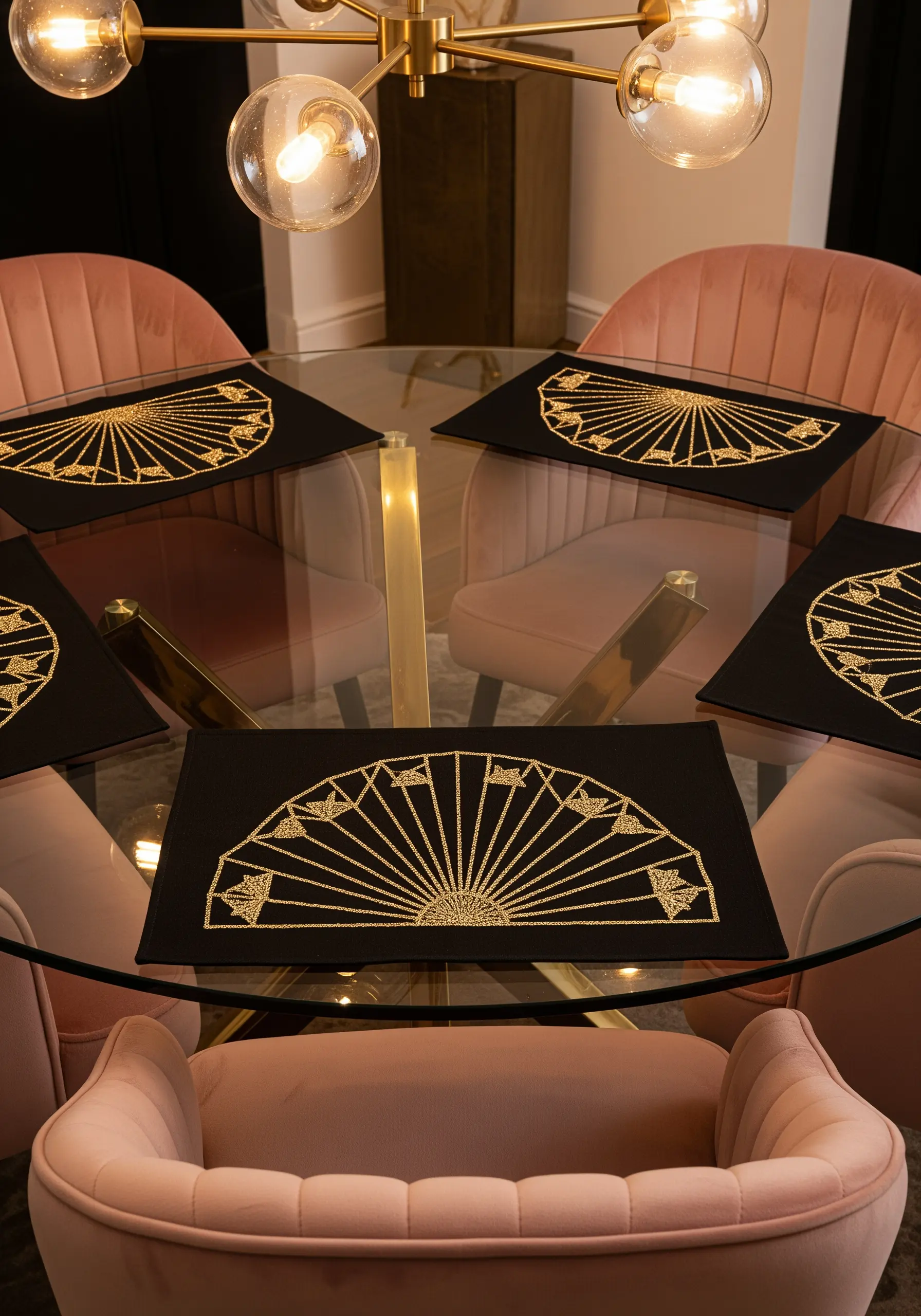Art Deco fan placemats embroidered in gold thread on black fabric.