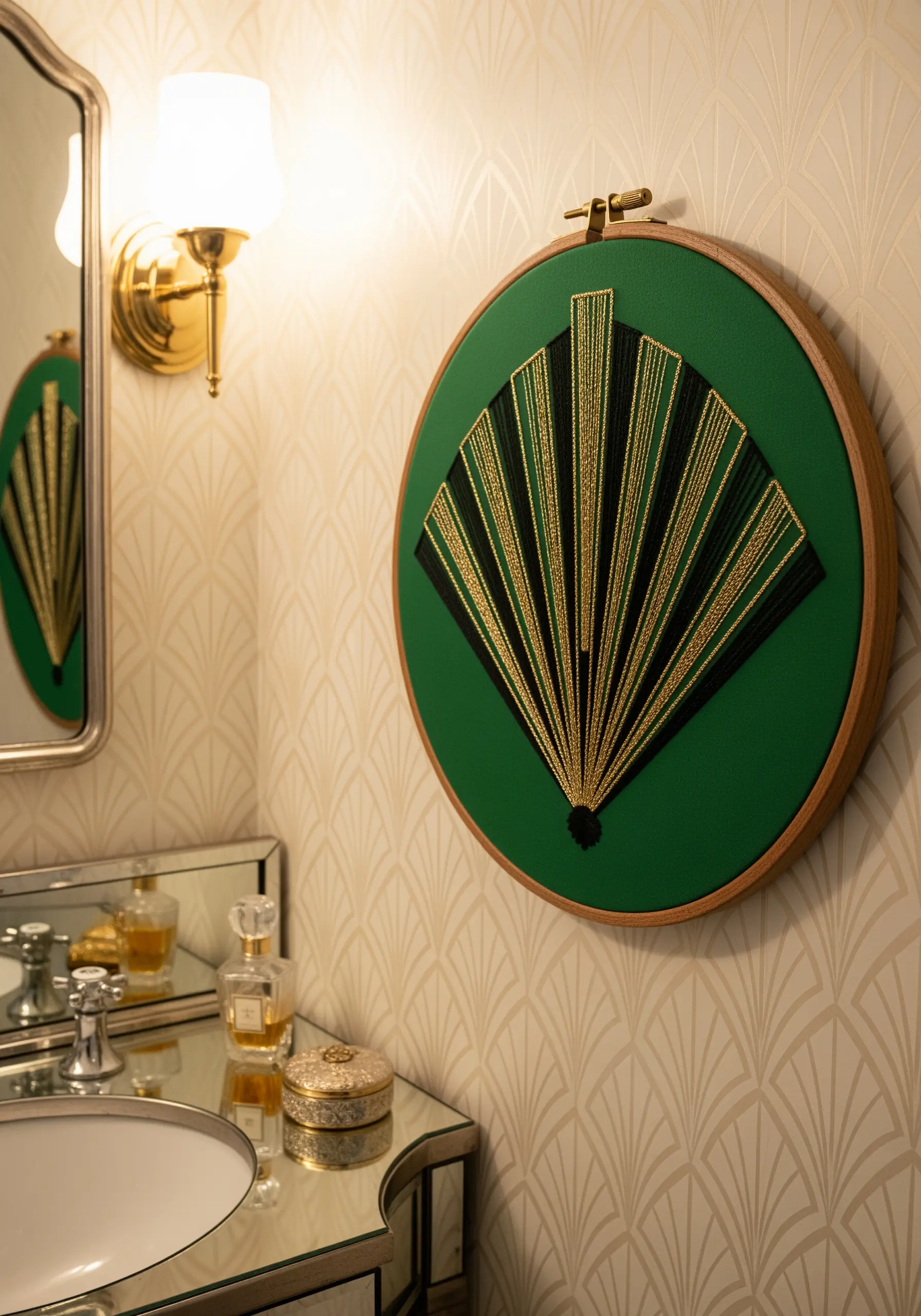 Art Deco fan design in black and gold thread on a green background.