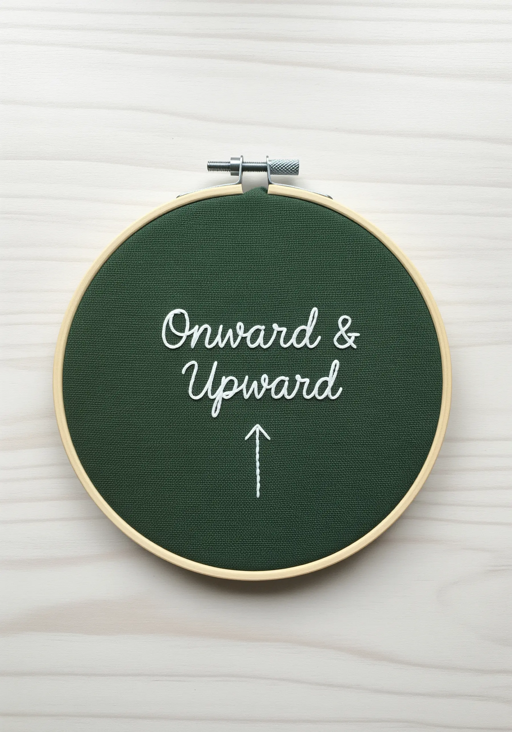 Cursive quote 'Onward & Upward' with a simple stitched arrow pointing up.