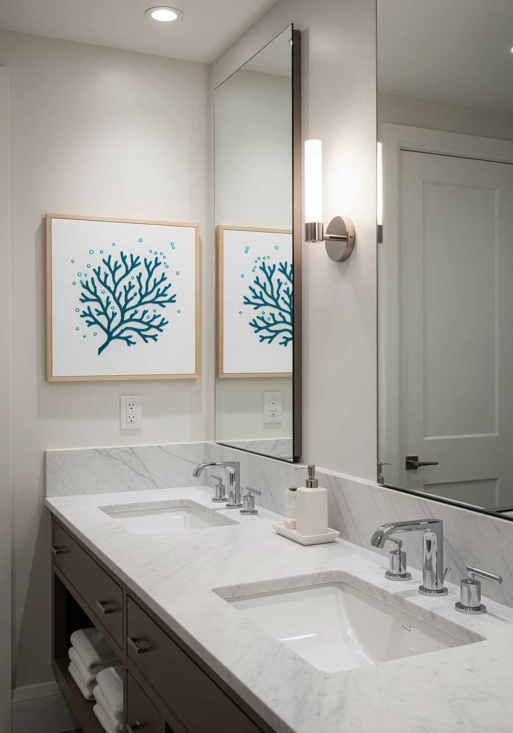 Framed embroidery of a teal coral branch with tiny French knot bubbles floating above it.