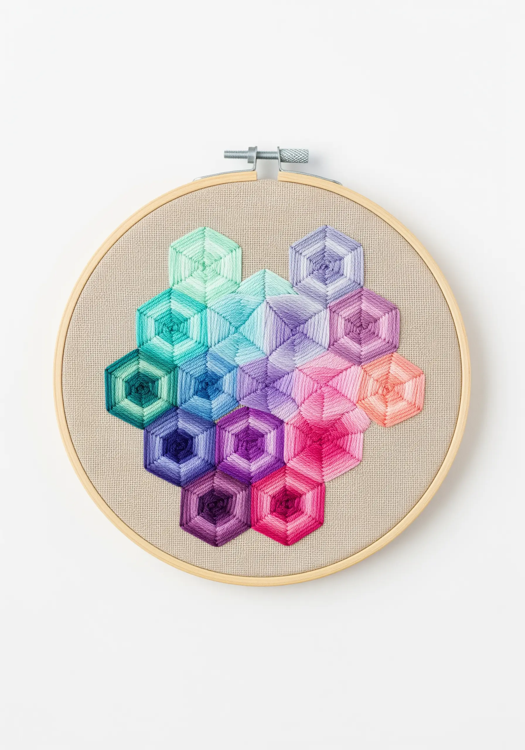 A geometric pattern of hexagons filled with radiating satin stitches in rainbow gradients.