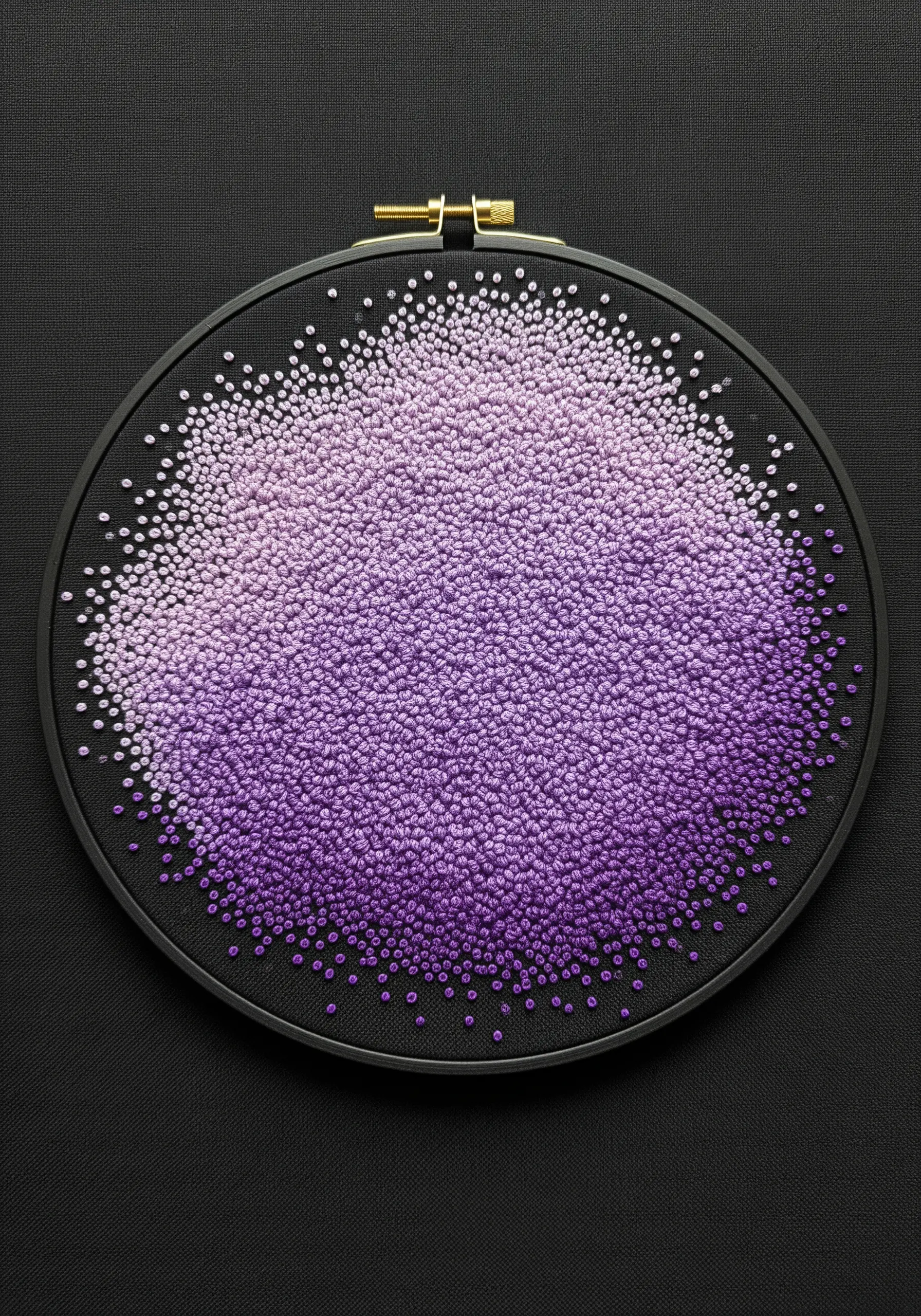 A dense cloud of French knots in a purple gradient on black fabric, from light to dark.