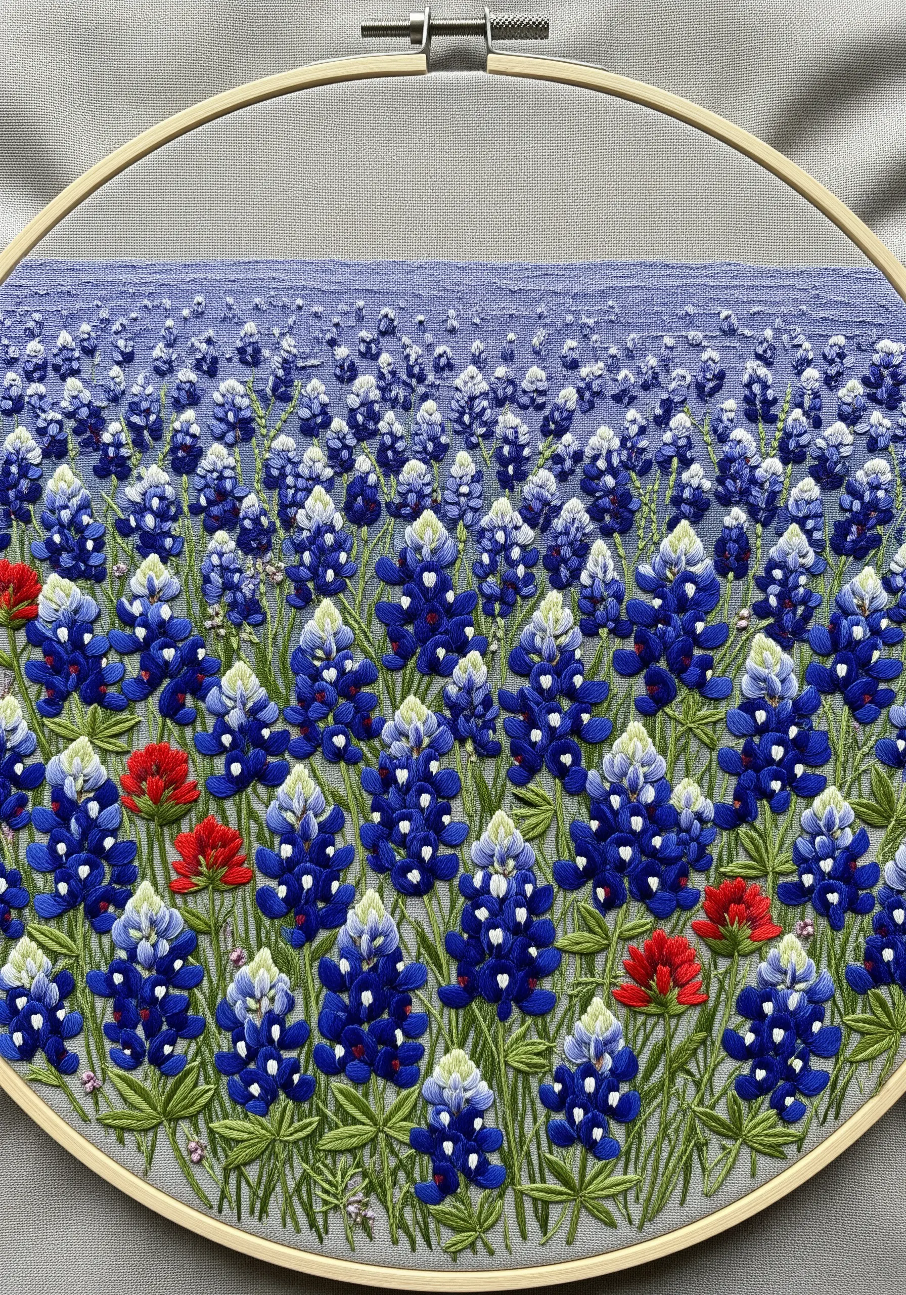 A dense and detailed embroidery of a field of Texas bluebonnets.