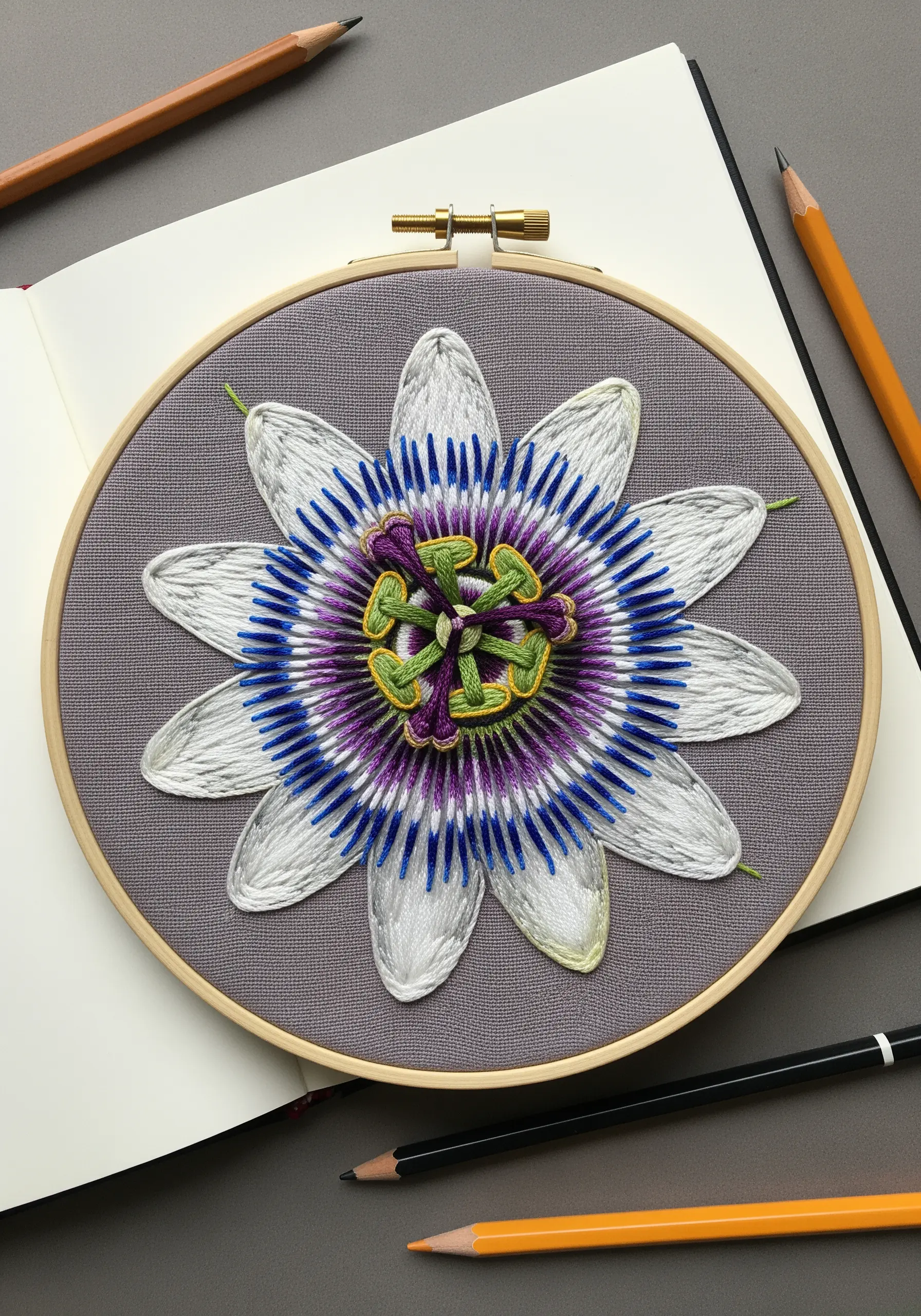 Detailed passion flower embroidery with French knots and bullion stitches in the center.