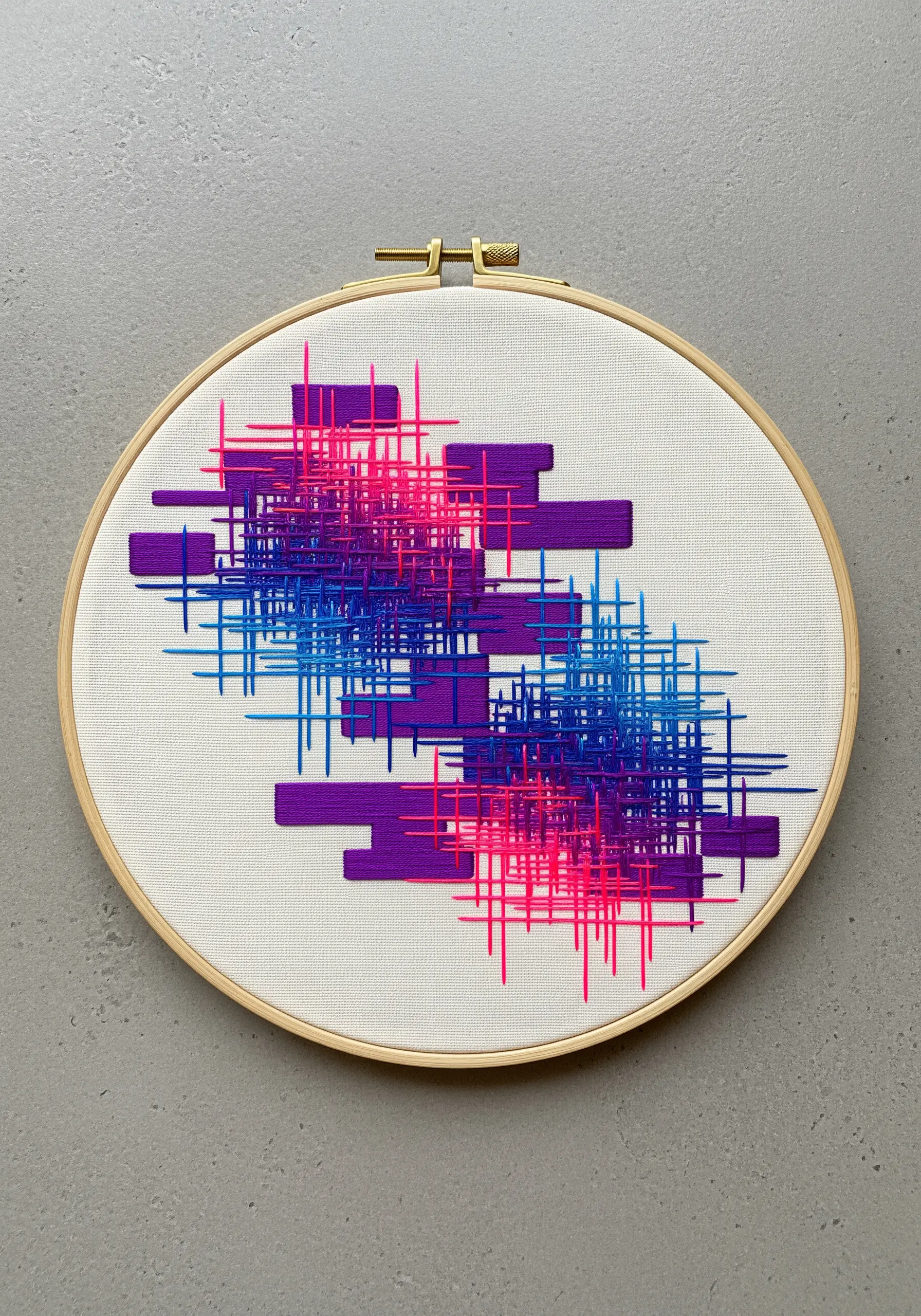 Abstract hoop art with intersecting grids of pink, blue, and purple straight stitches.
