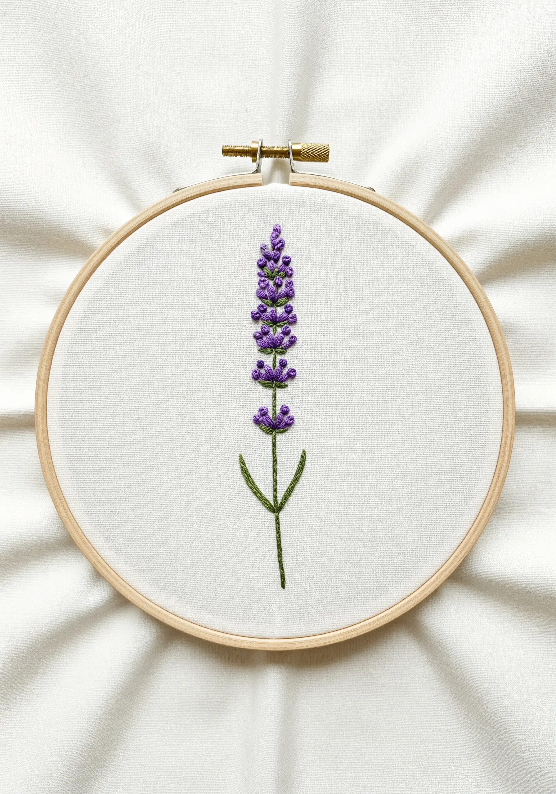 An embroidered lavender stalk with purple French knots and a green stem.