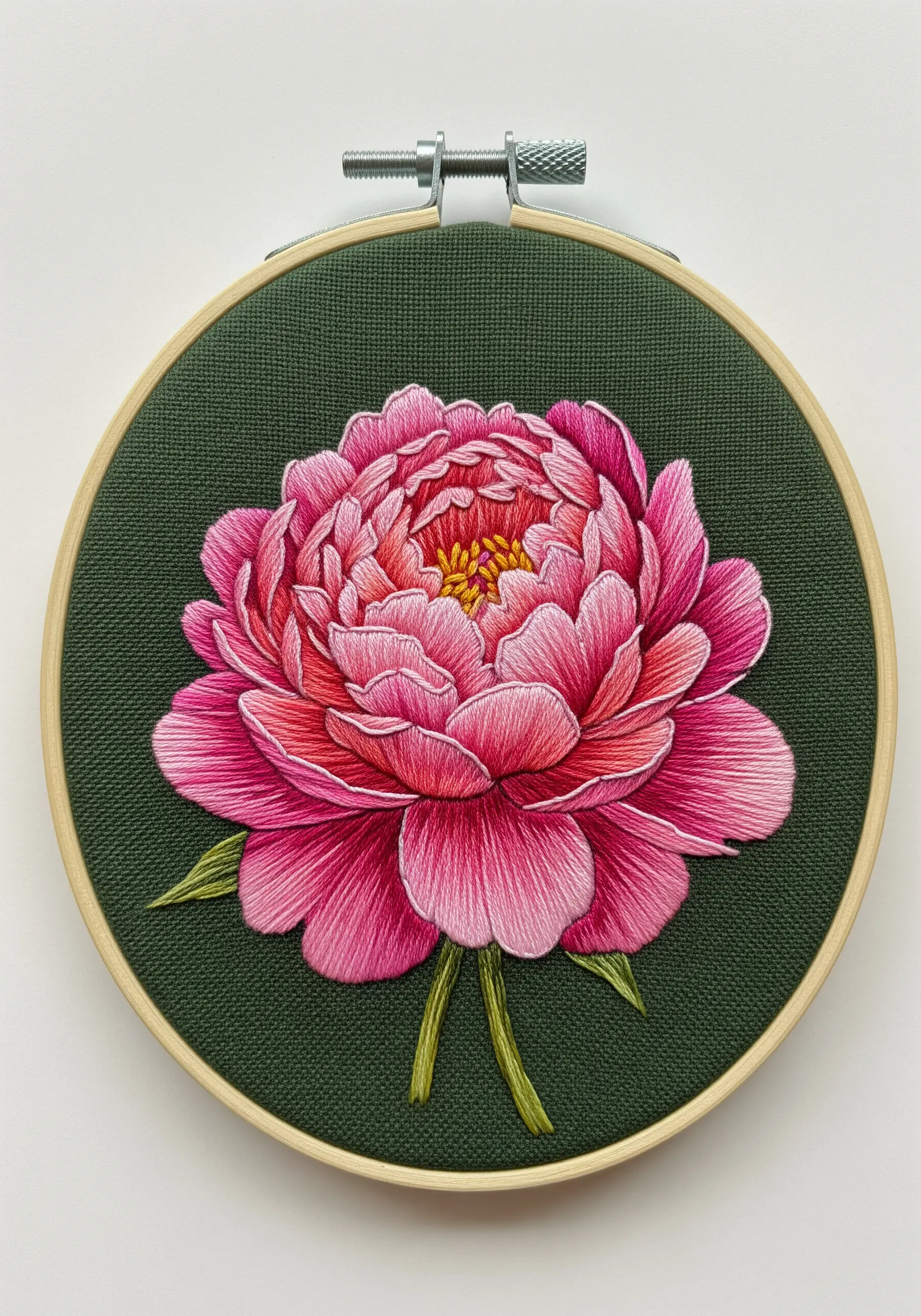 A highly detailed, thread-painted pink peony on dark green fabric.