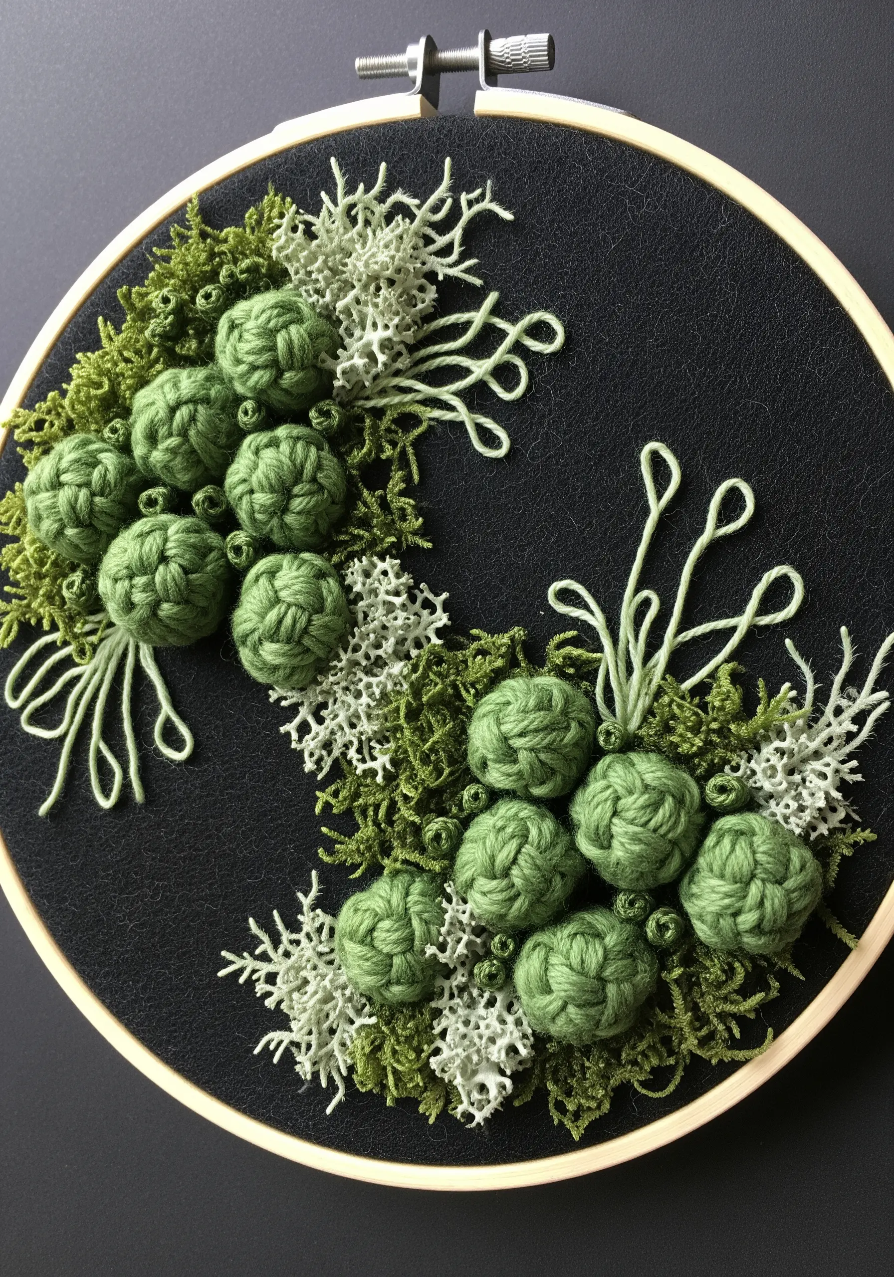 Dimensional embroidery of green moss and lichen textures using bullion knots and turkey work.