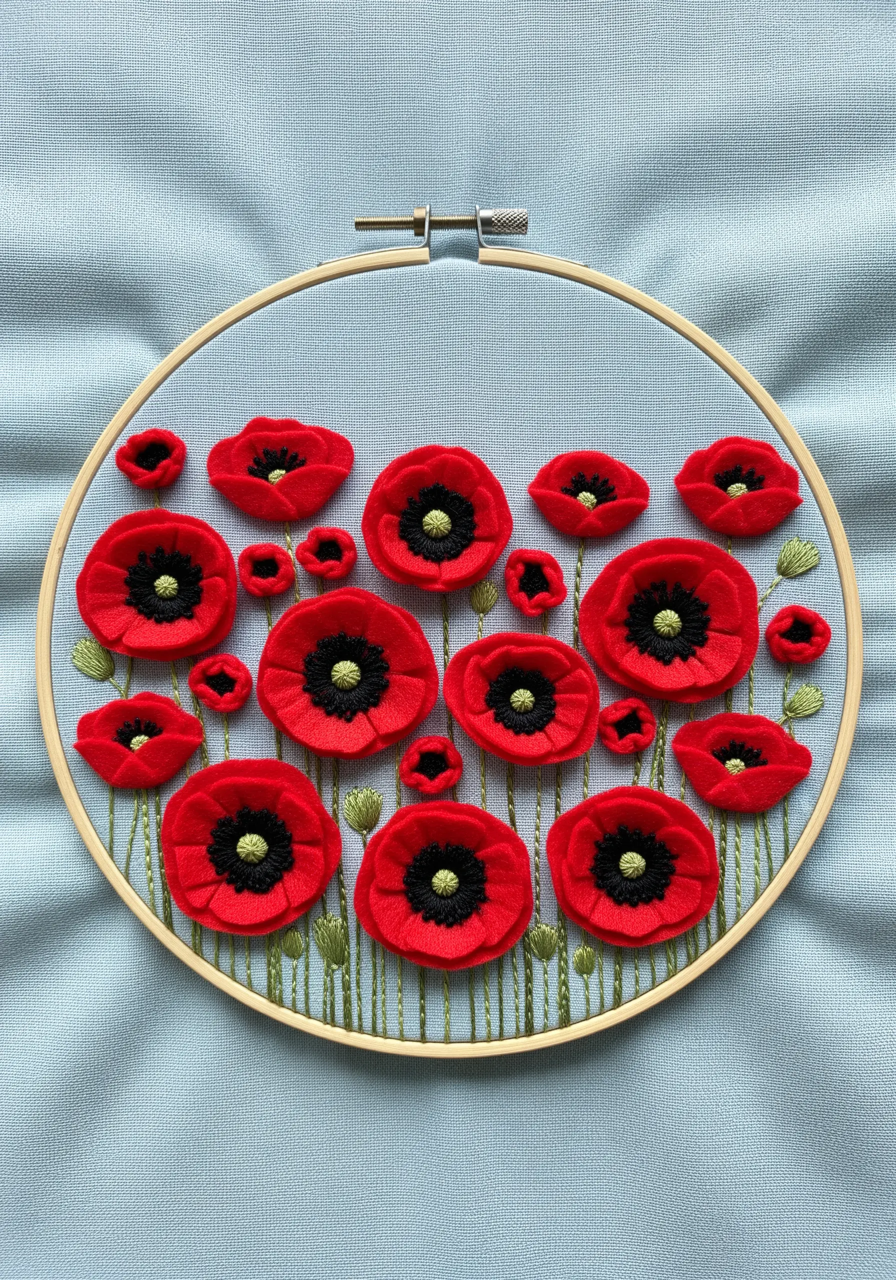 A field of 3D red poppies created with layered felt and embroidery in a hoop.