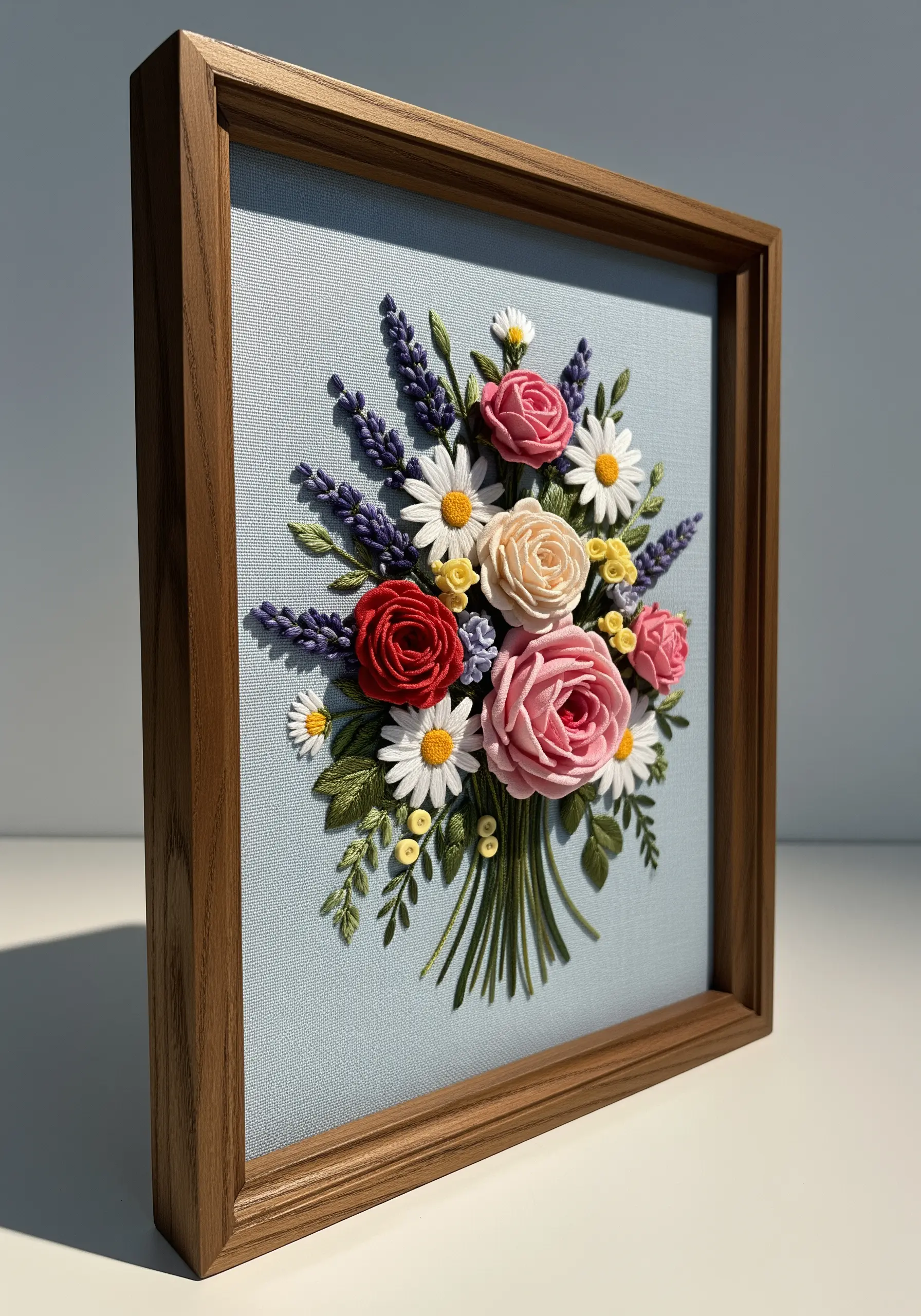 3D embroidered bouquet of roses, lavender, and daisies in a wooden frame.