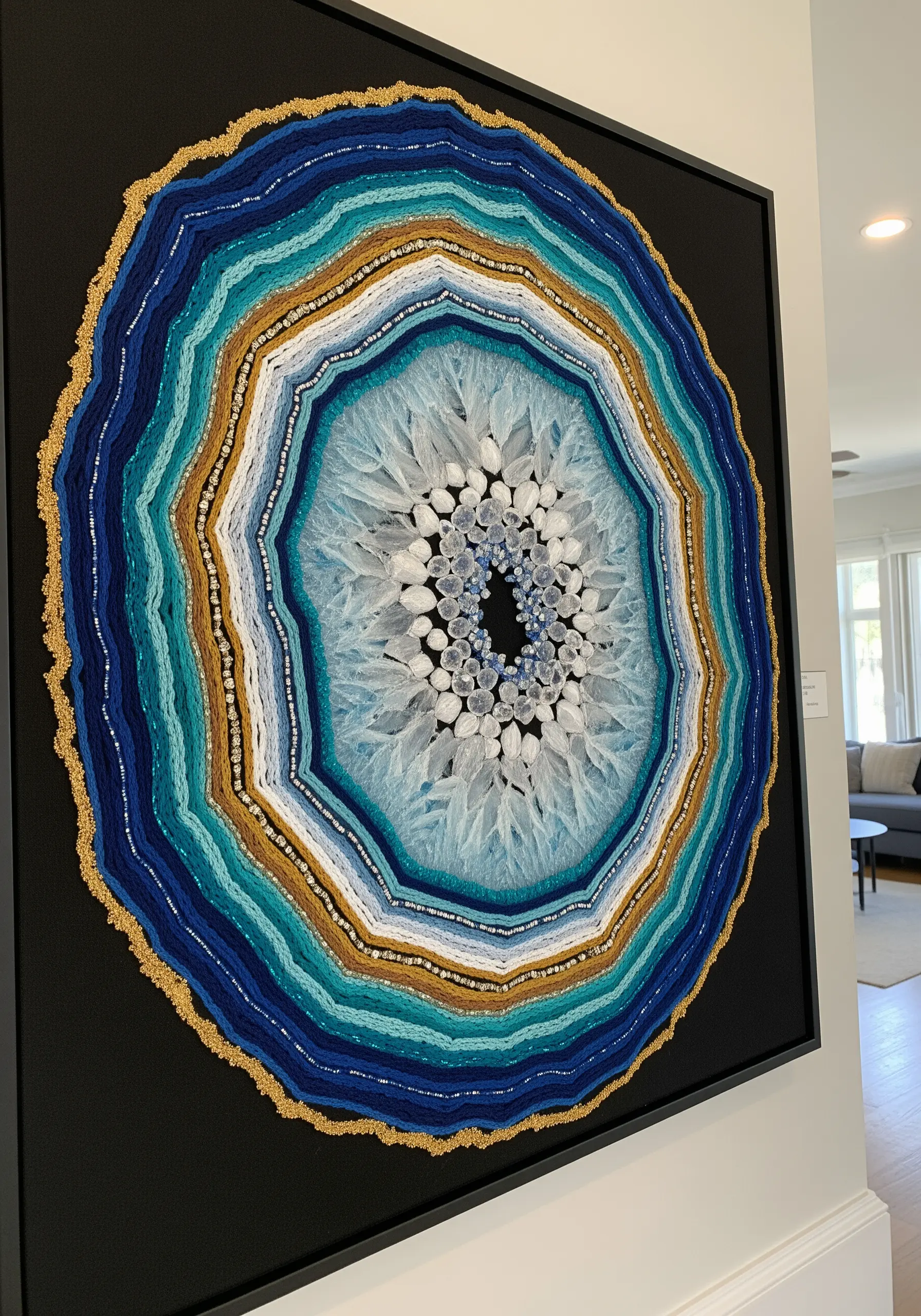 Large framed geode embroidery with blue, gold, and white threads and beads.