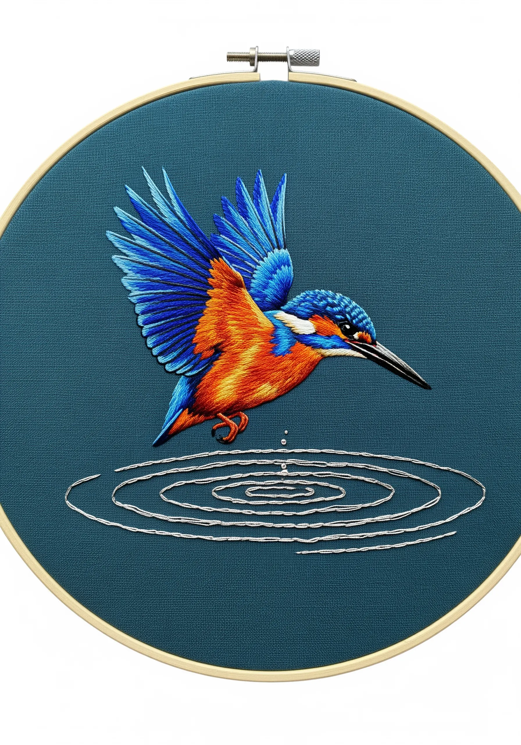 An embroidered kingfisher diving towards water, with silver thread water ripples.
