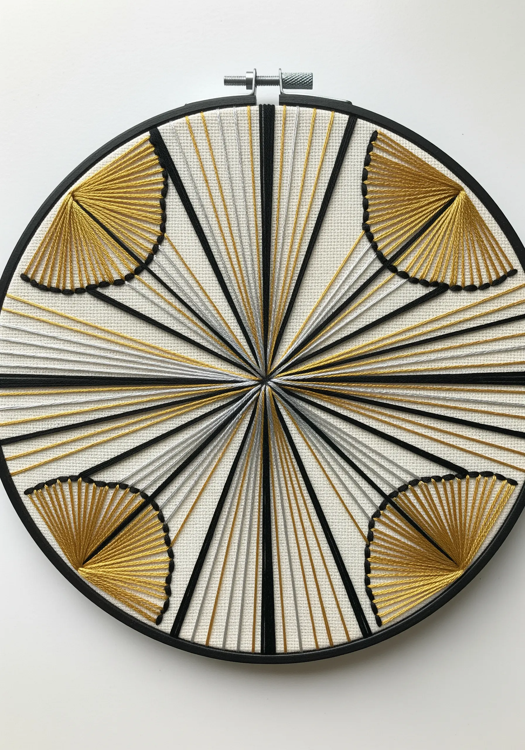 Art Deco string art embroidery with radiating lines and metallic fan shapes.