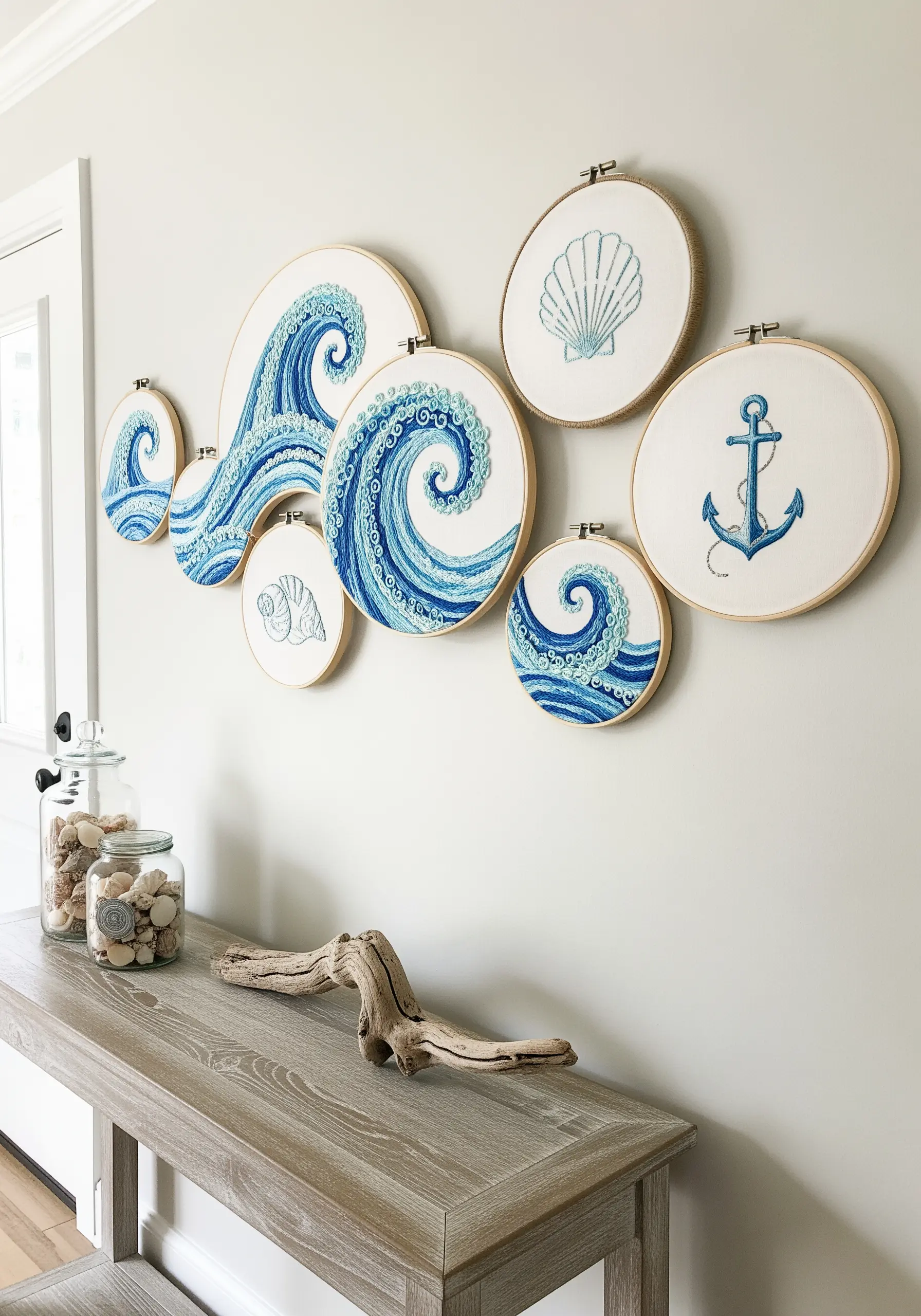 A collection of embroidery hoops depicting swirling blue ocean waves and seashells.