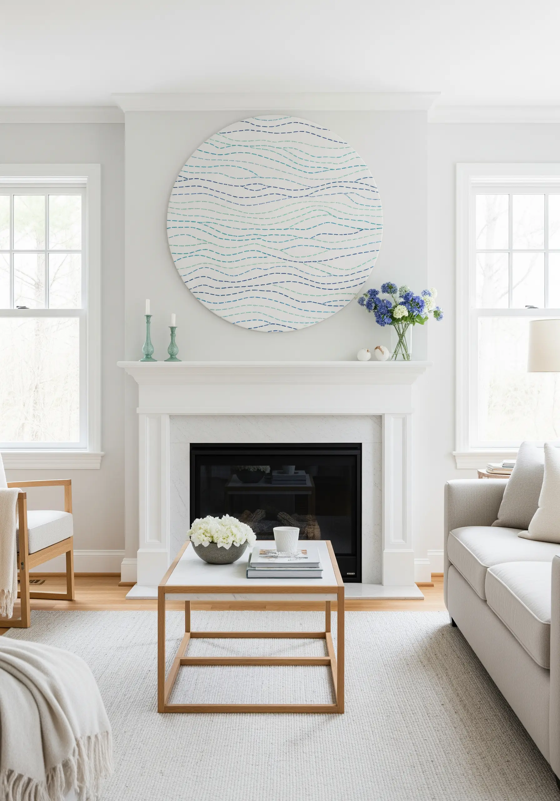 A large, circular embroidery piece with wavy lines in shades of blue hangs over a fireplace