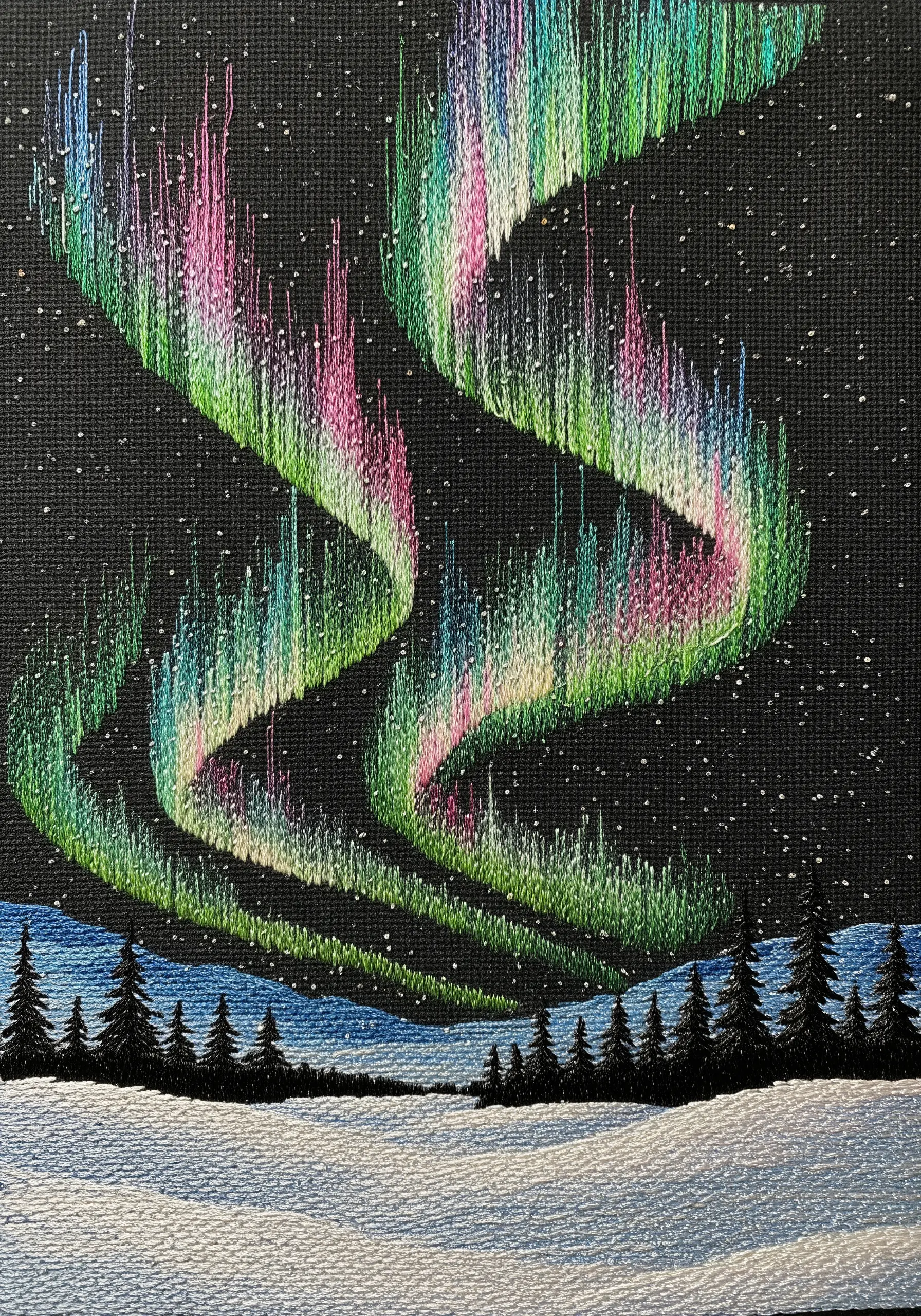 Embroidery of the Aurora Borealis with vibrant vertical stitches on black fabric.