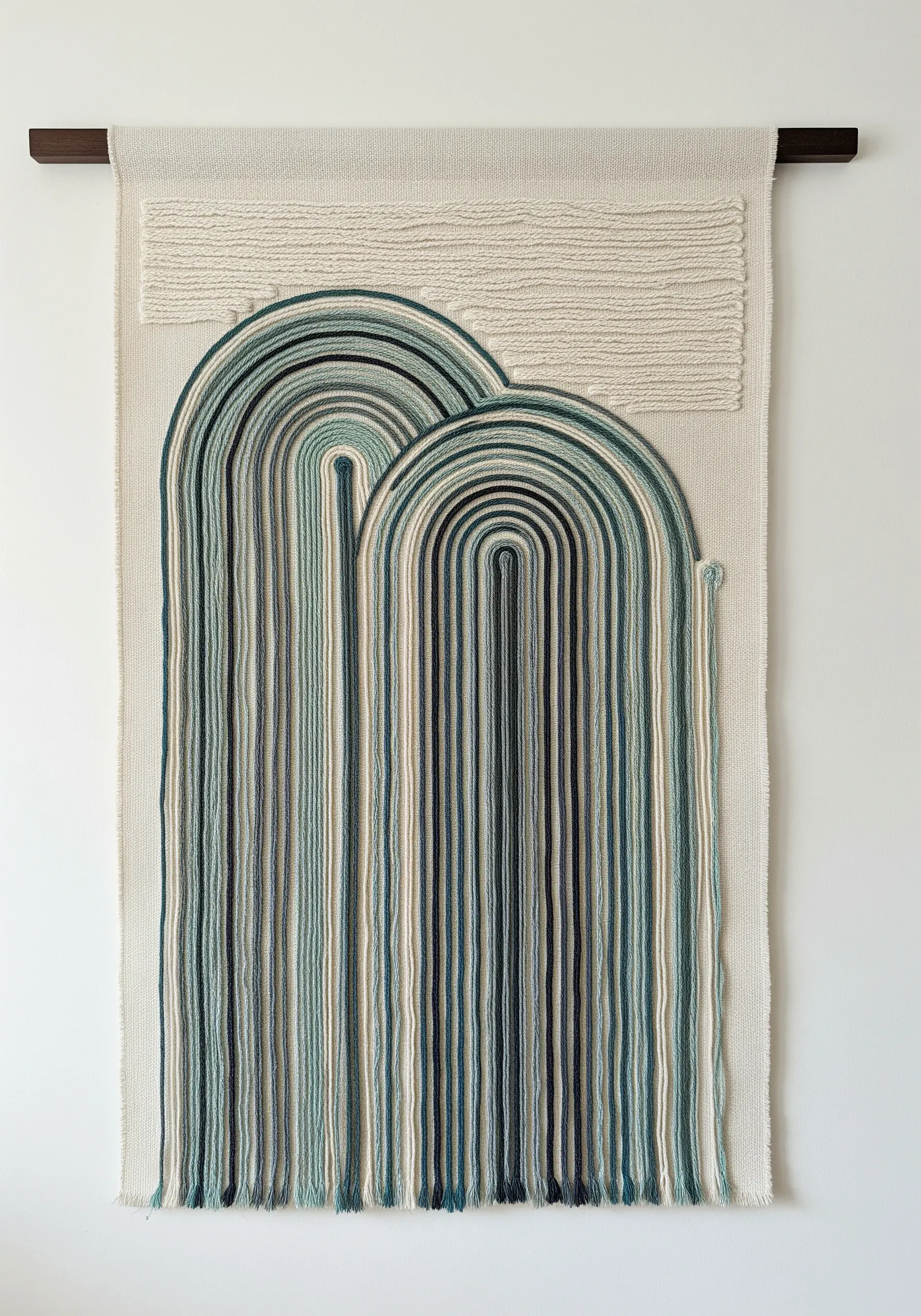 Large textile wall hanging with cascading threads in green and blue hues forming arch shapes.