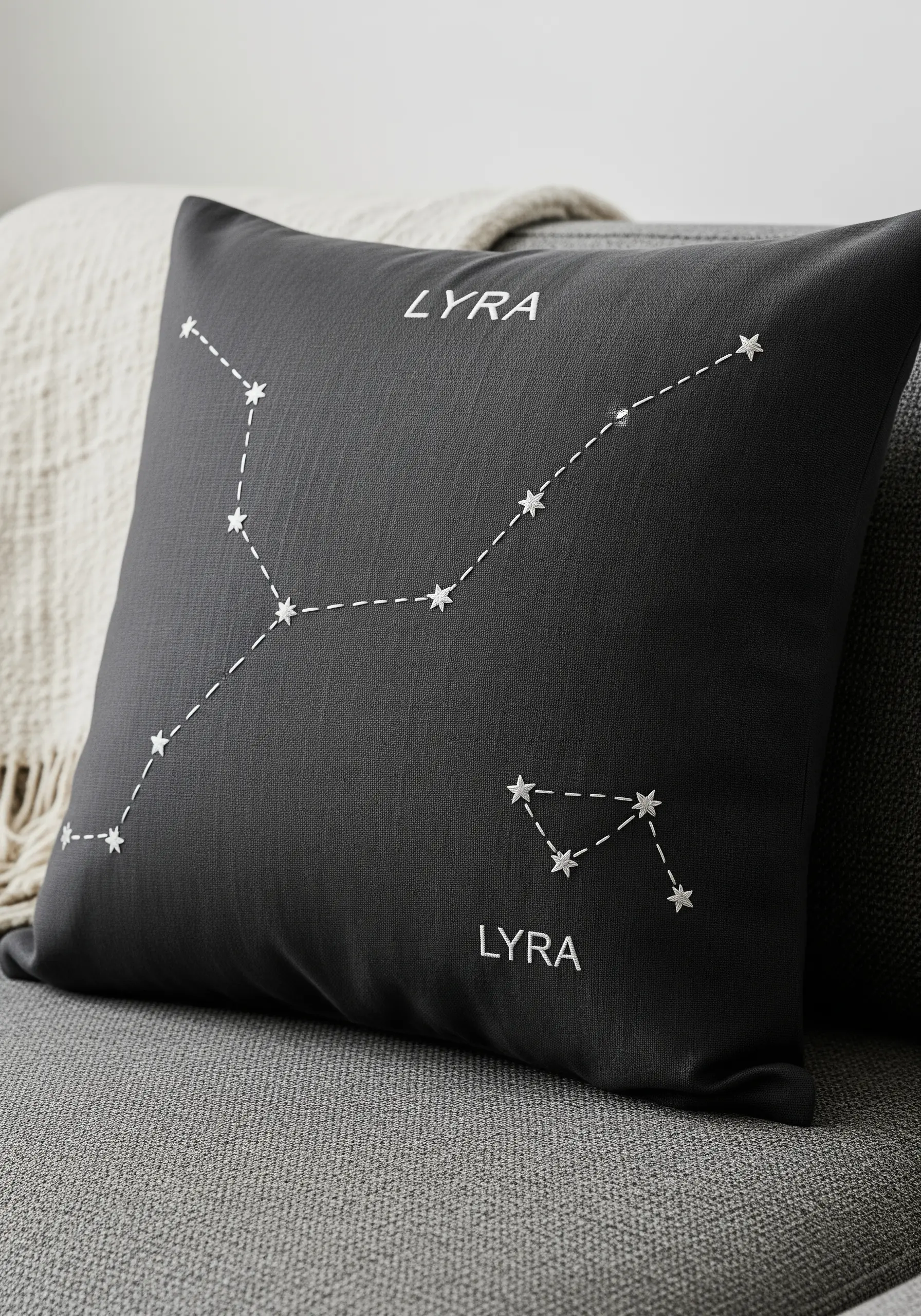 Embroidered Lyra constellation with star stitches on a dark grey cushion cover.
