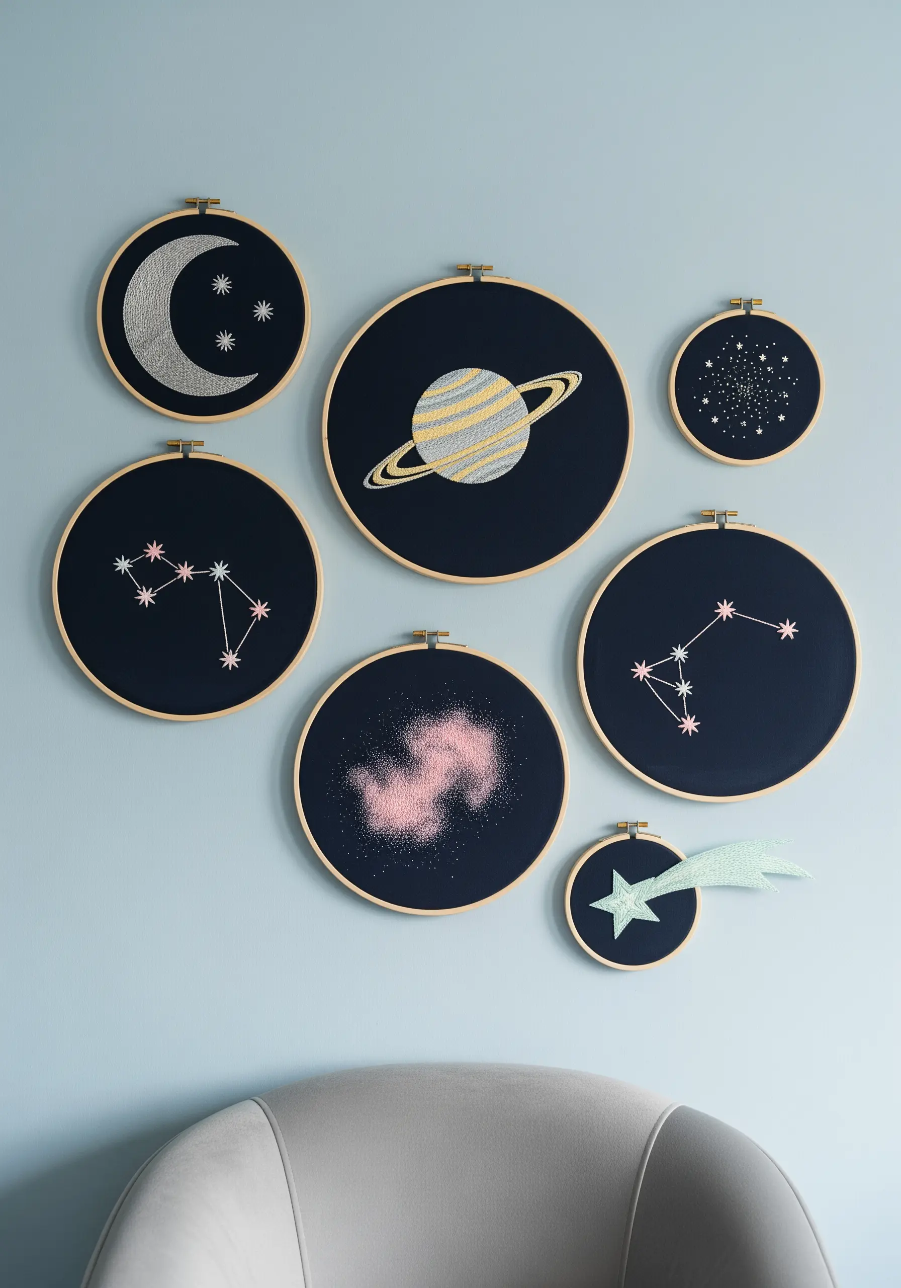 A gallery wall of celestial embroidery hoops featuring constellations and planets.