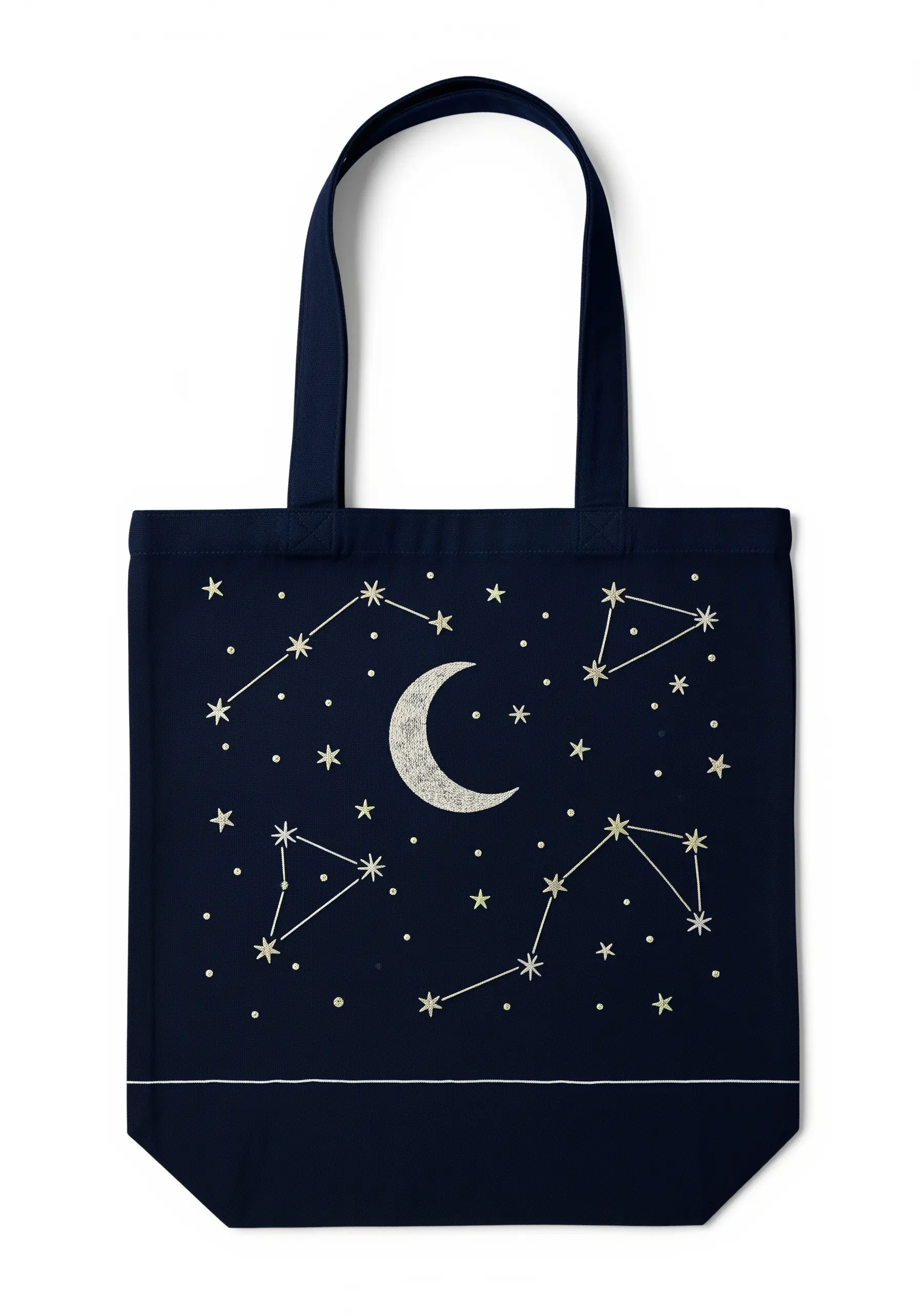 A night sky with an embroidered moon and constellations on a navy blue tote bag.