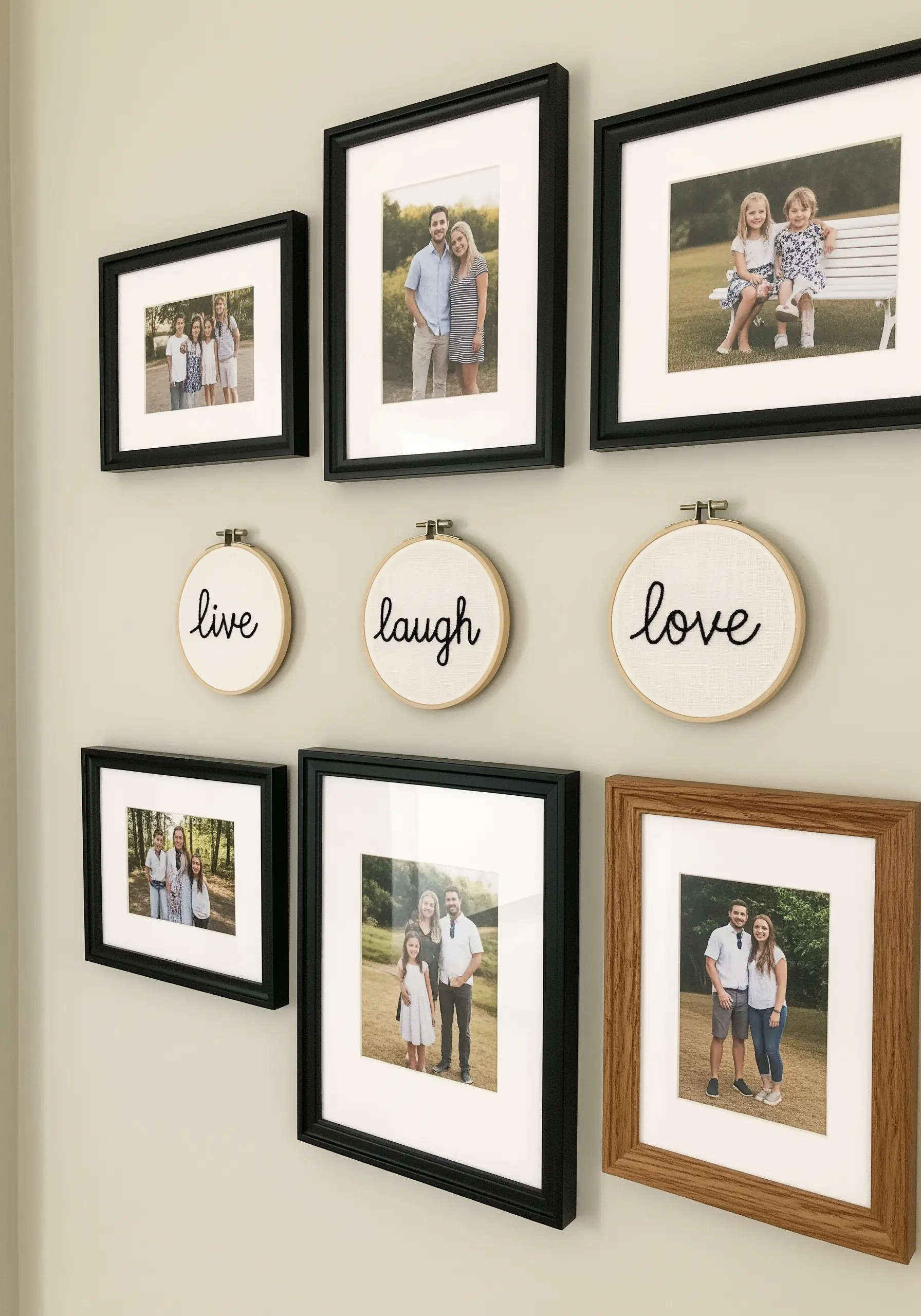 Three small embroidery hoops with 'live,' 'laugh,' and 'love' stitched in black script.