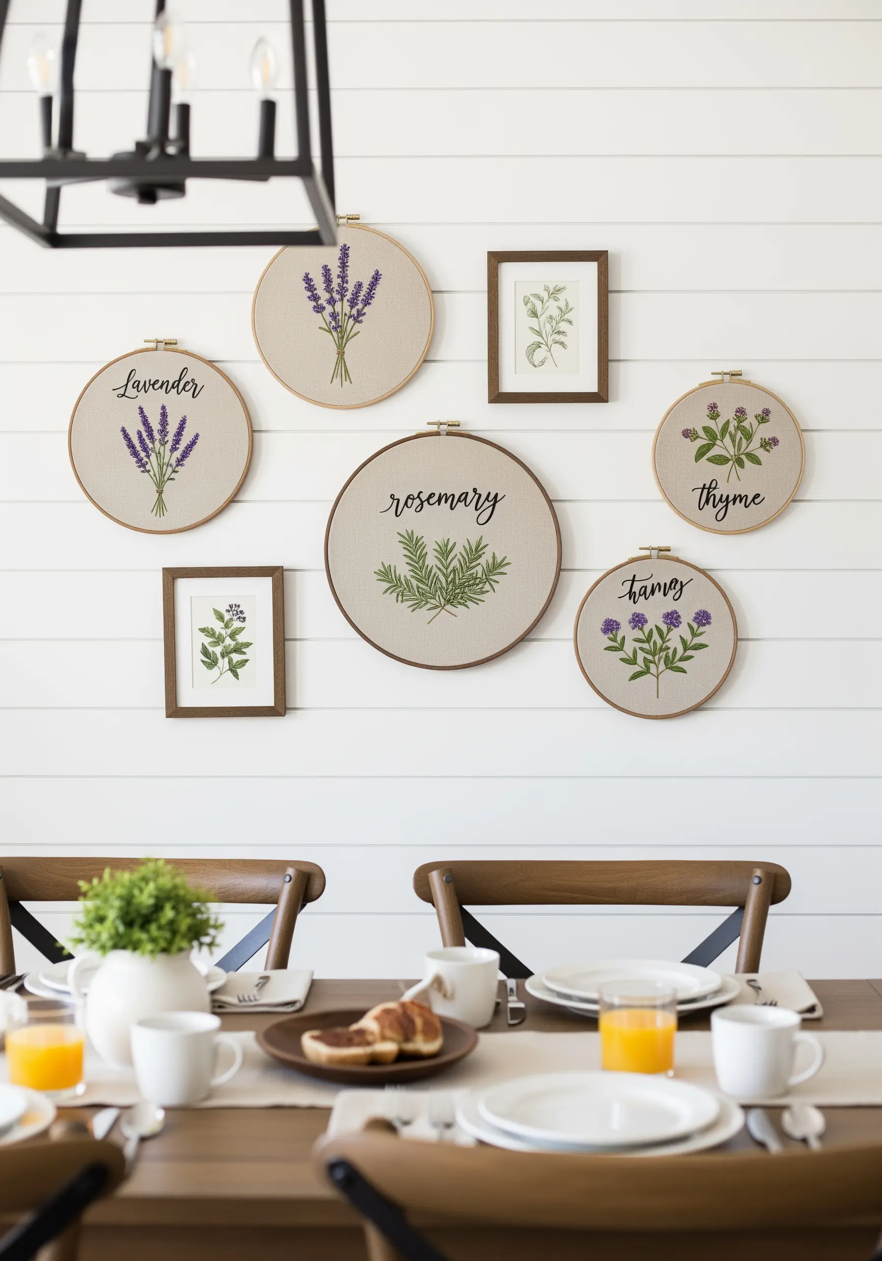 A wall display of embroidered hoops with lavender, rosemary, and thyme motifs and lettering.