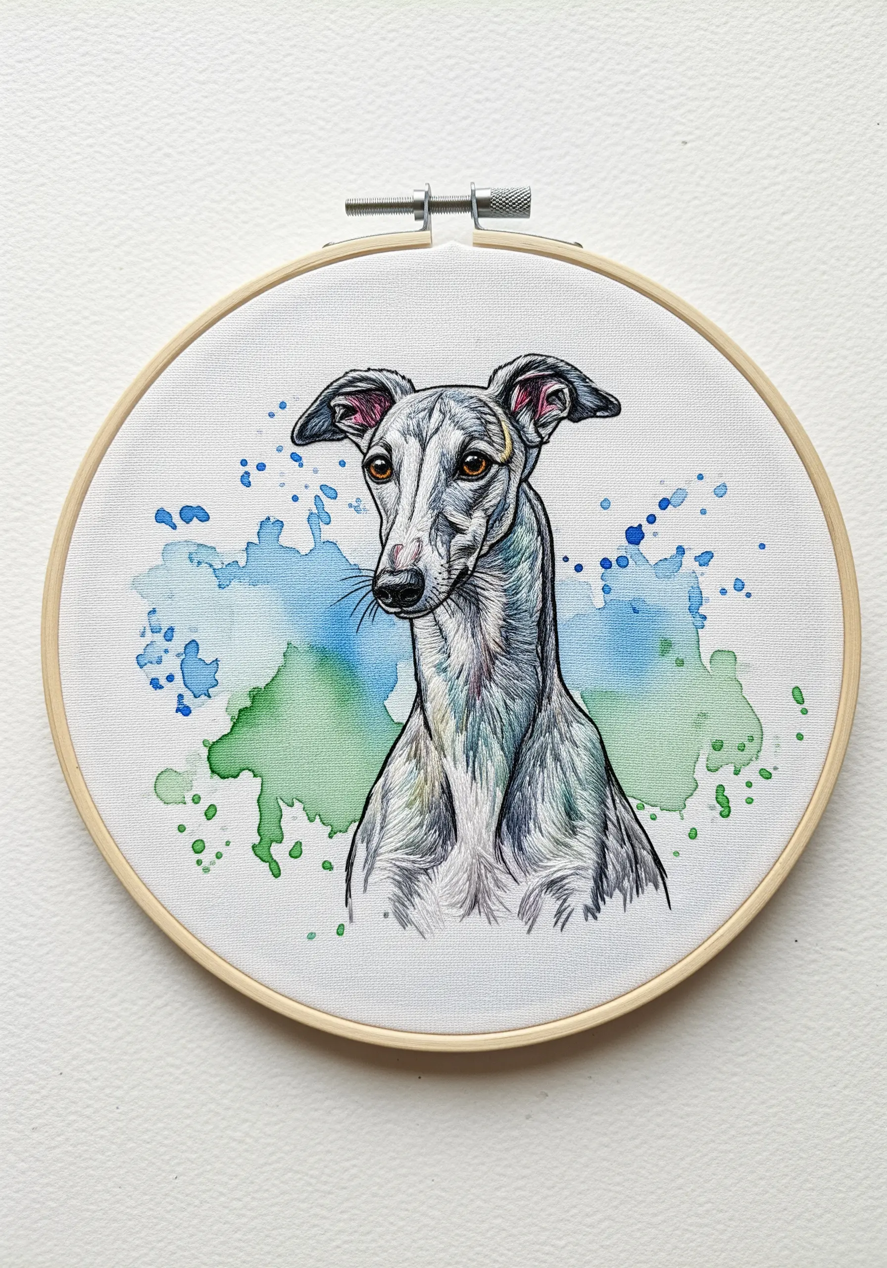 Embroidery of a greyhound with a blue and green watercolor splash in the background.