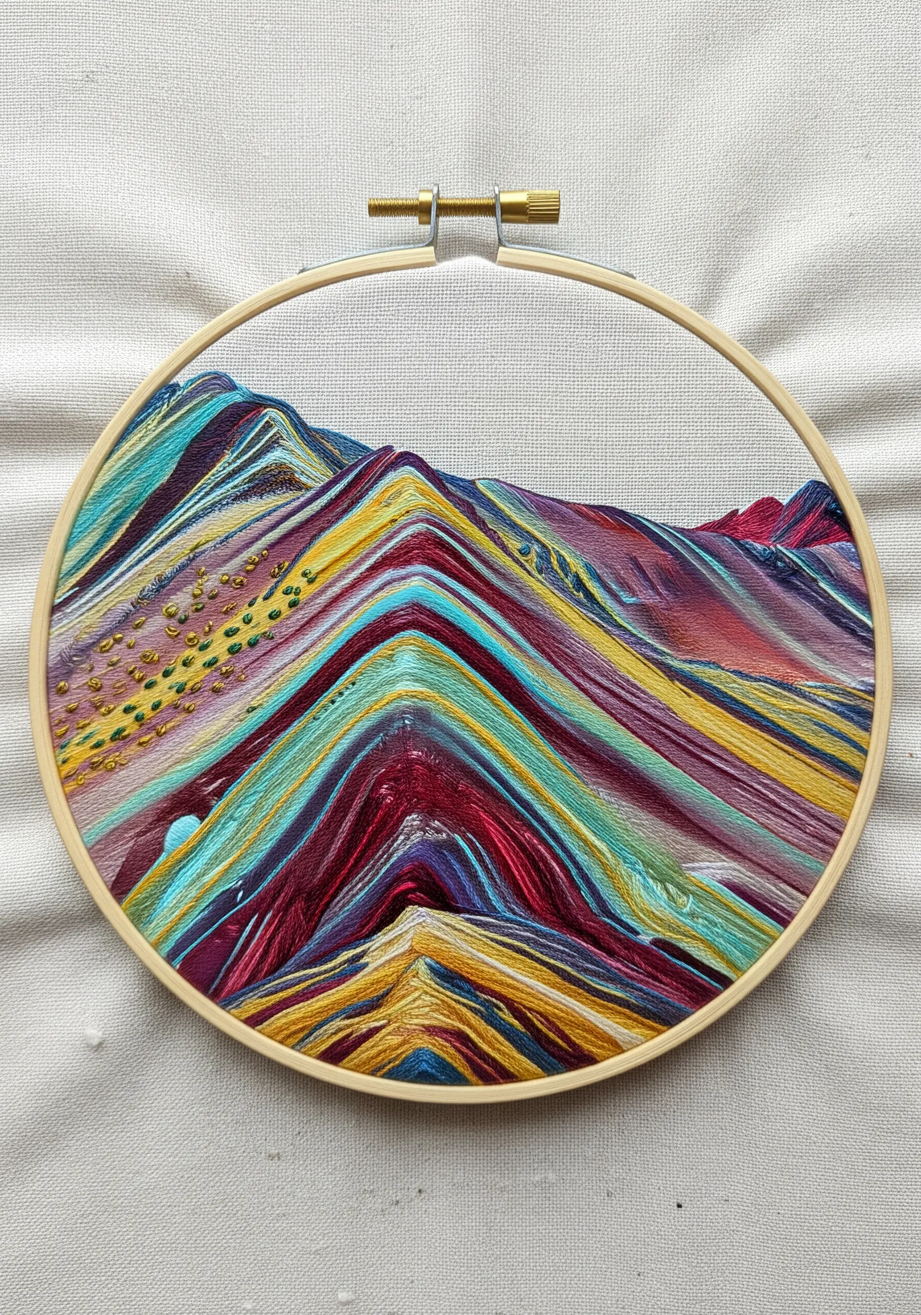 Embroidery of Peru's Rainbow Mountain, with vivid colors enhanced by a painted fabric base.