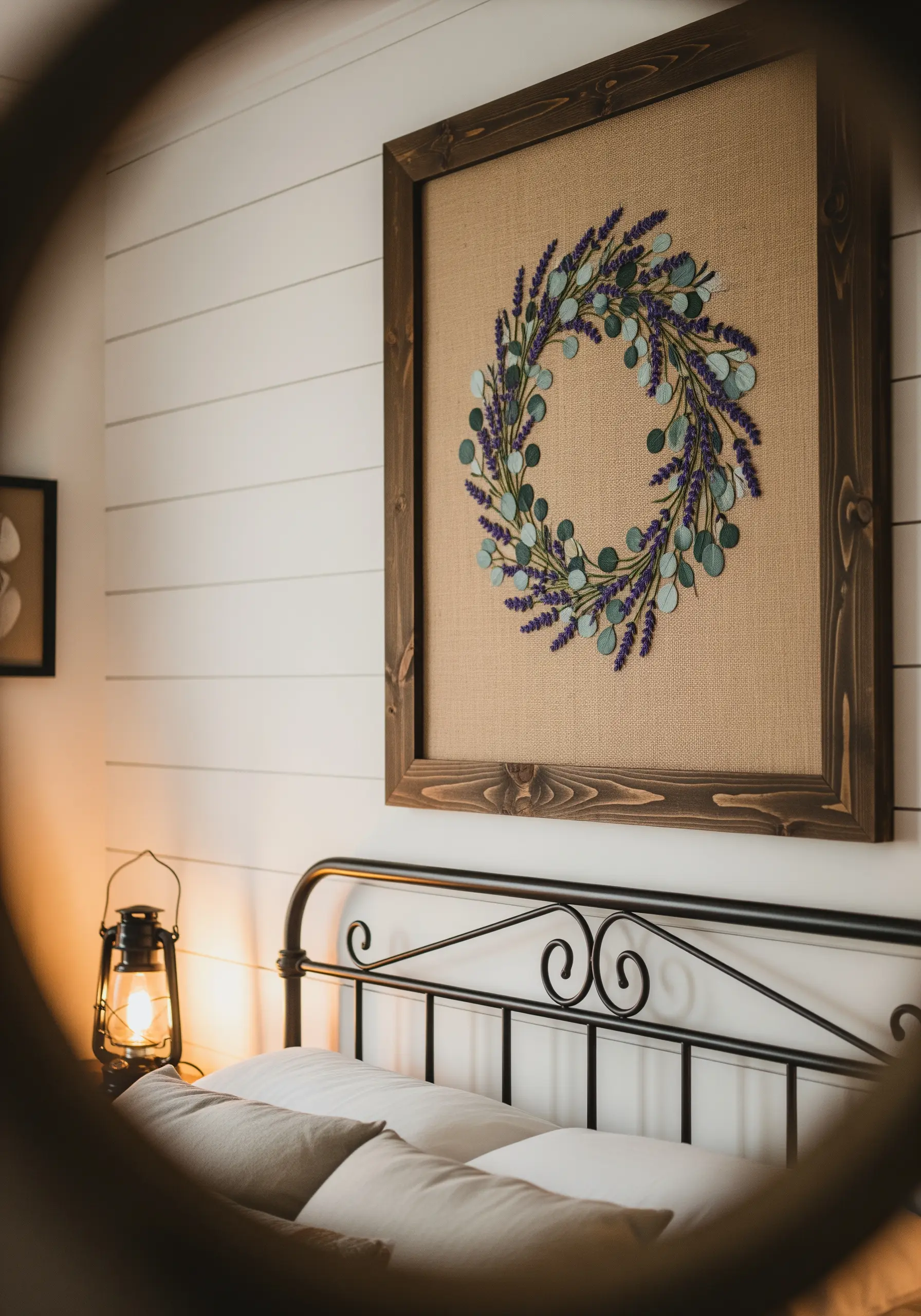 Embroidered lavender and eucalyptus wreath on burlap fabric in a dark wood frame.