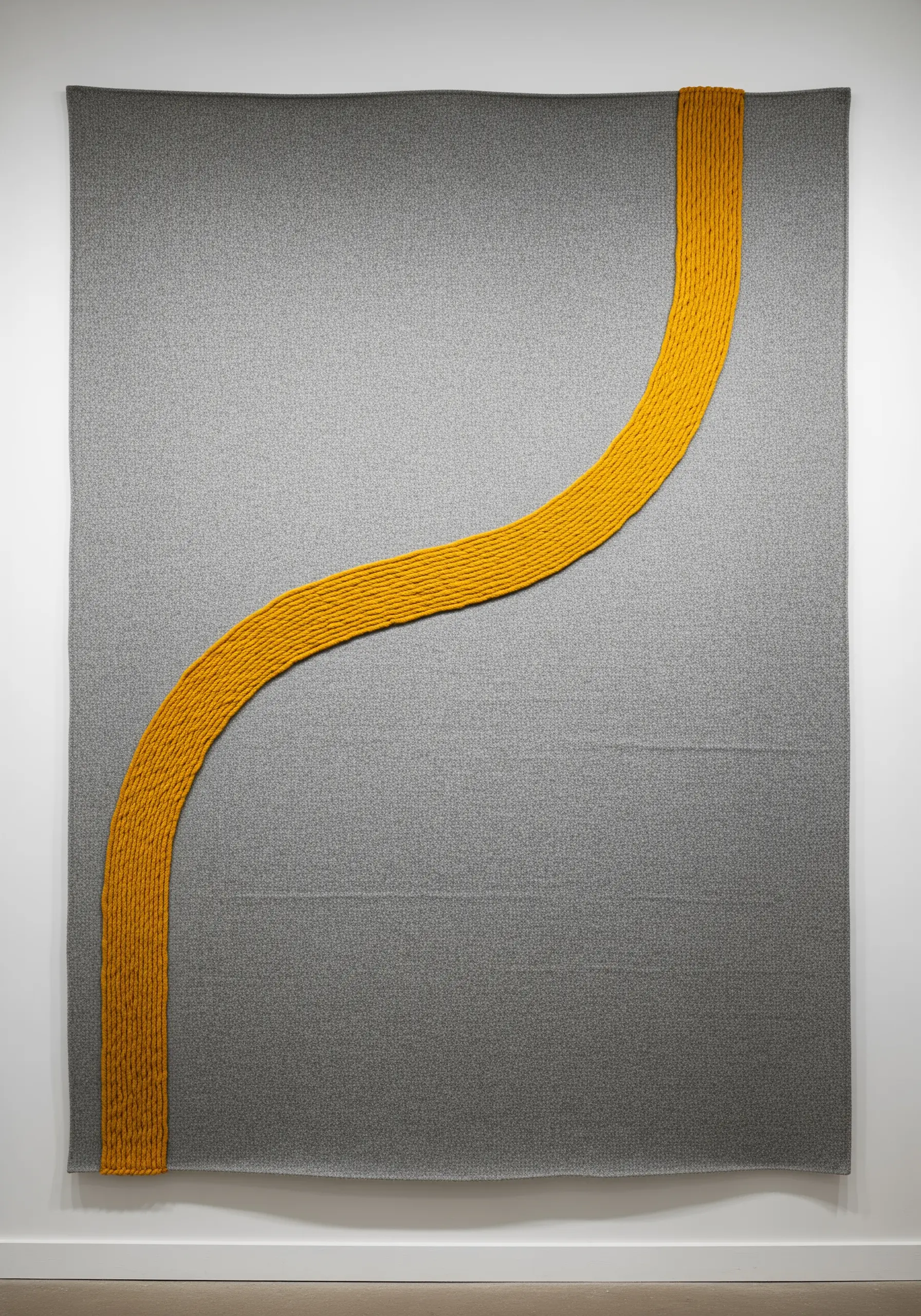 Large grey textile wall art with a single, bold, textured S-curve in mustard yellow yarn.