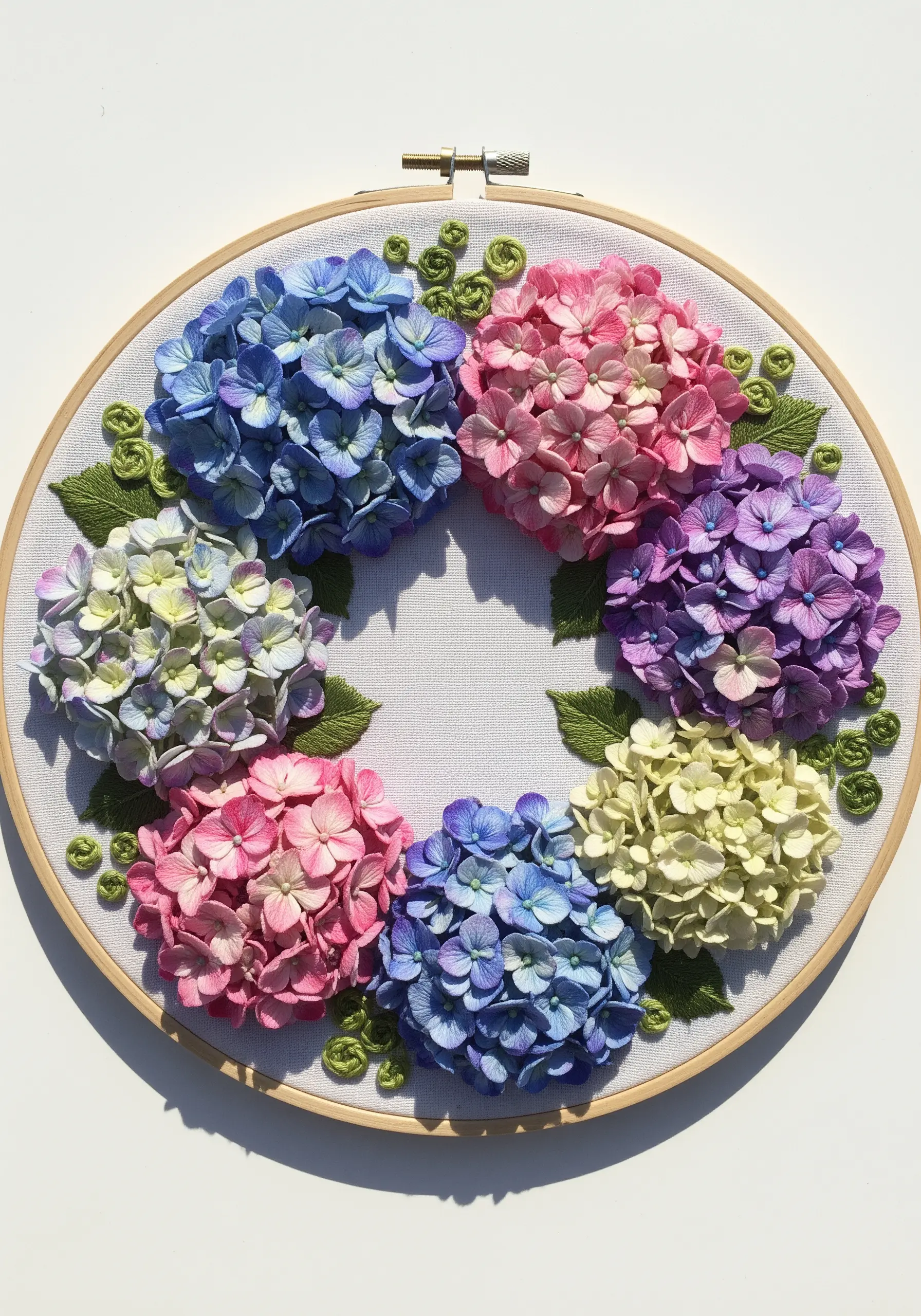 A hoop art wreath composed of multiple small hydrangea clusters in various colors.