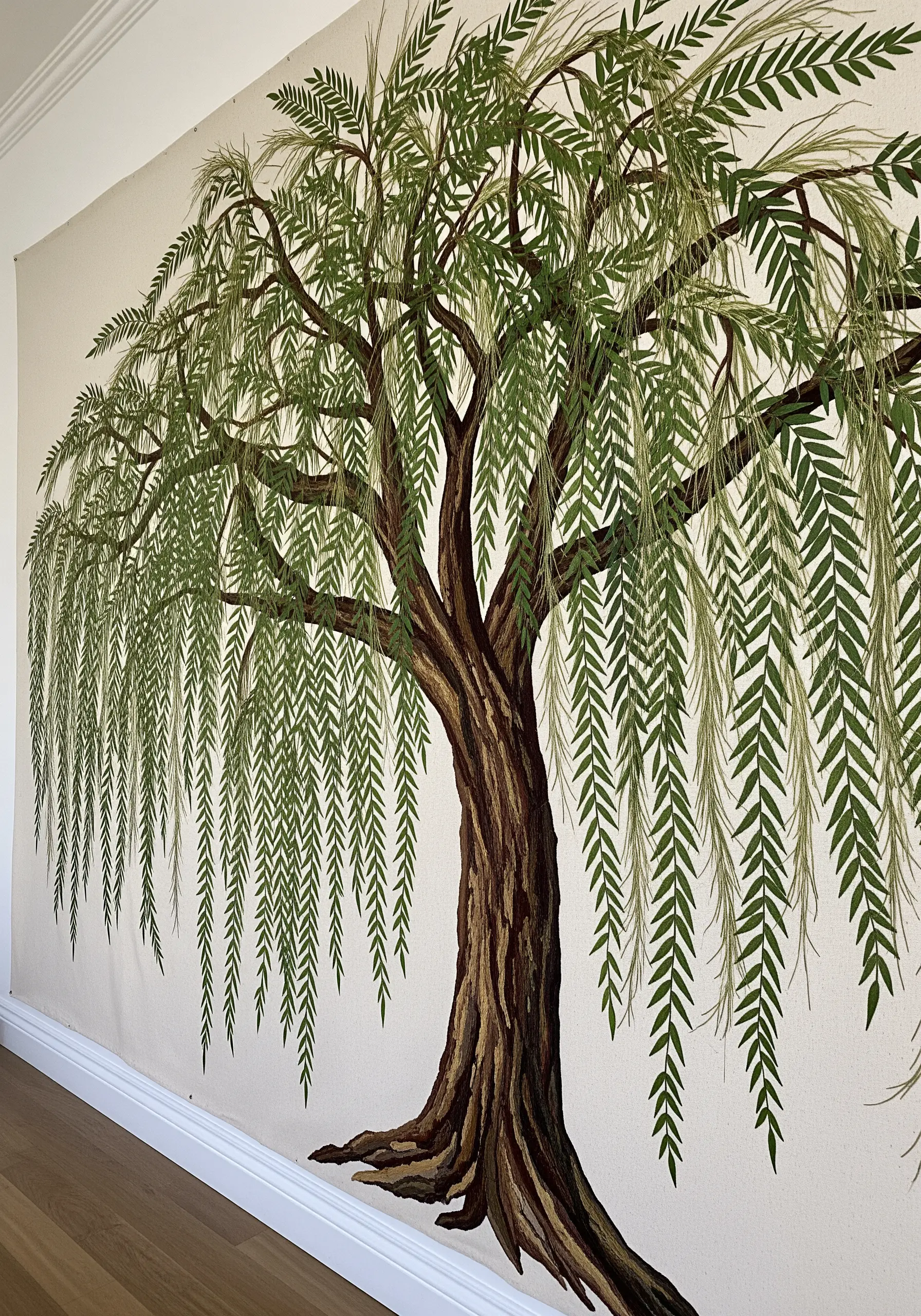 A large wall tapestry of a weeping willow tree made from individual pressed leaves.