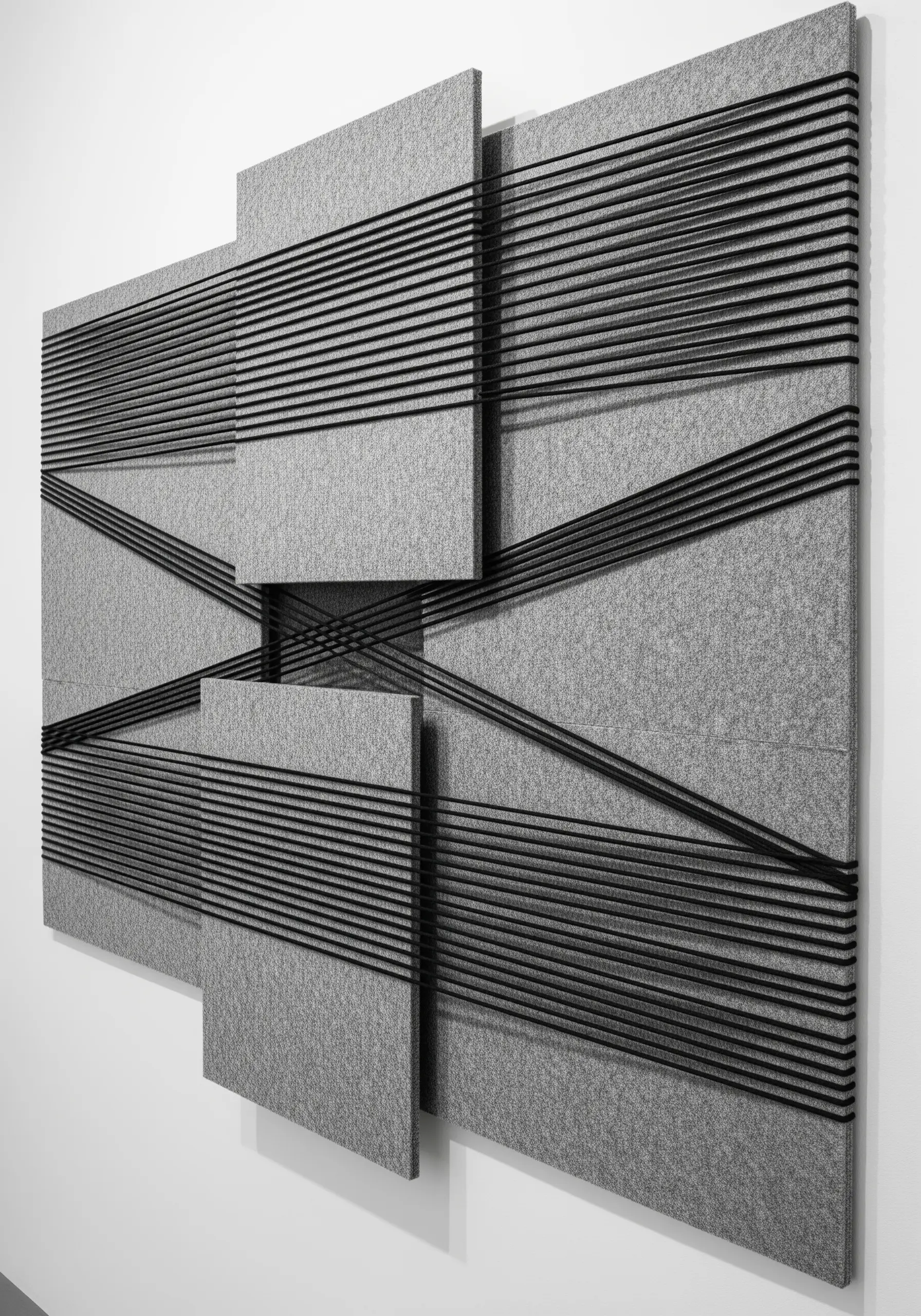 An architectural wall art piece with black threads stretched across overlapping gray felt panels.