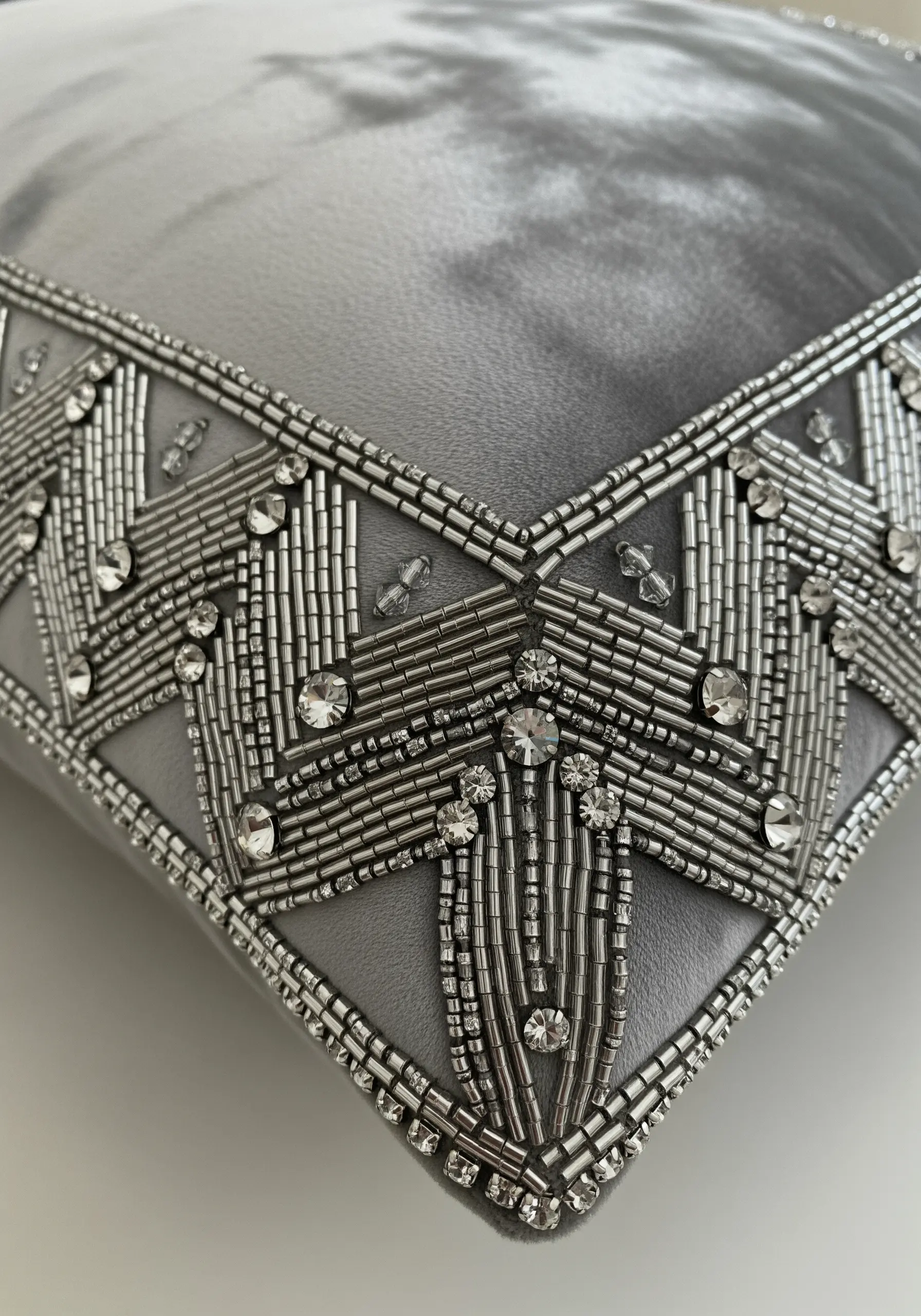 A glamorous Art Deco border made with silver bugle beads and crystals on grey velvet