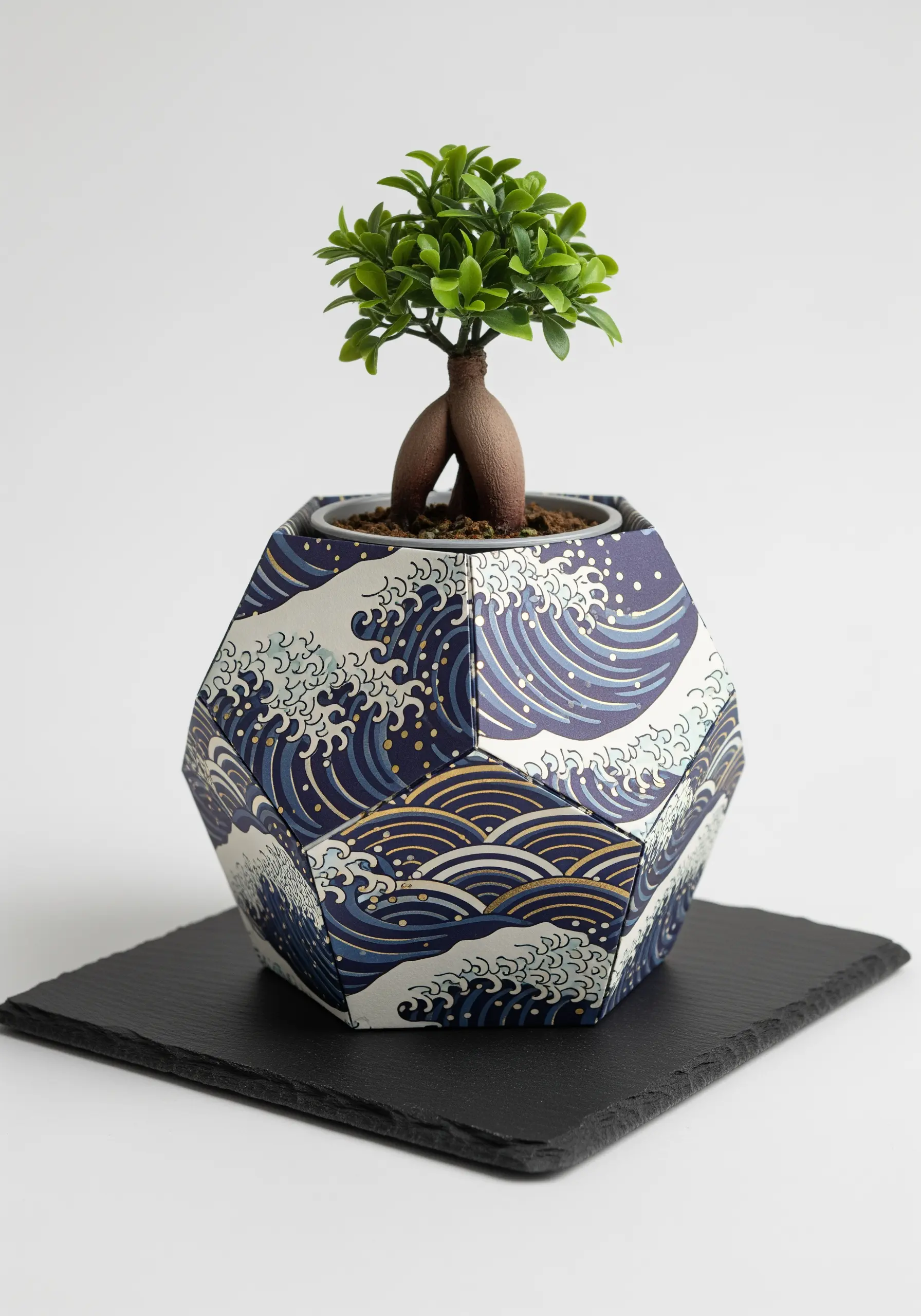 A geometric planter folded from heavy paper featuring a classic Japanese 'Great Wave' pattern.