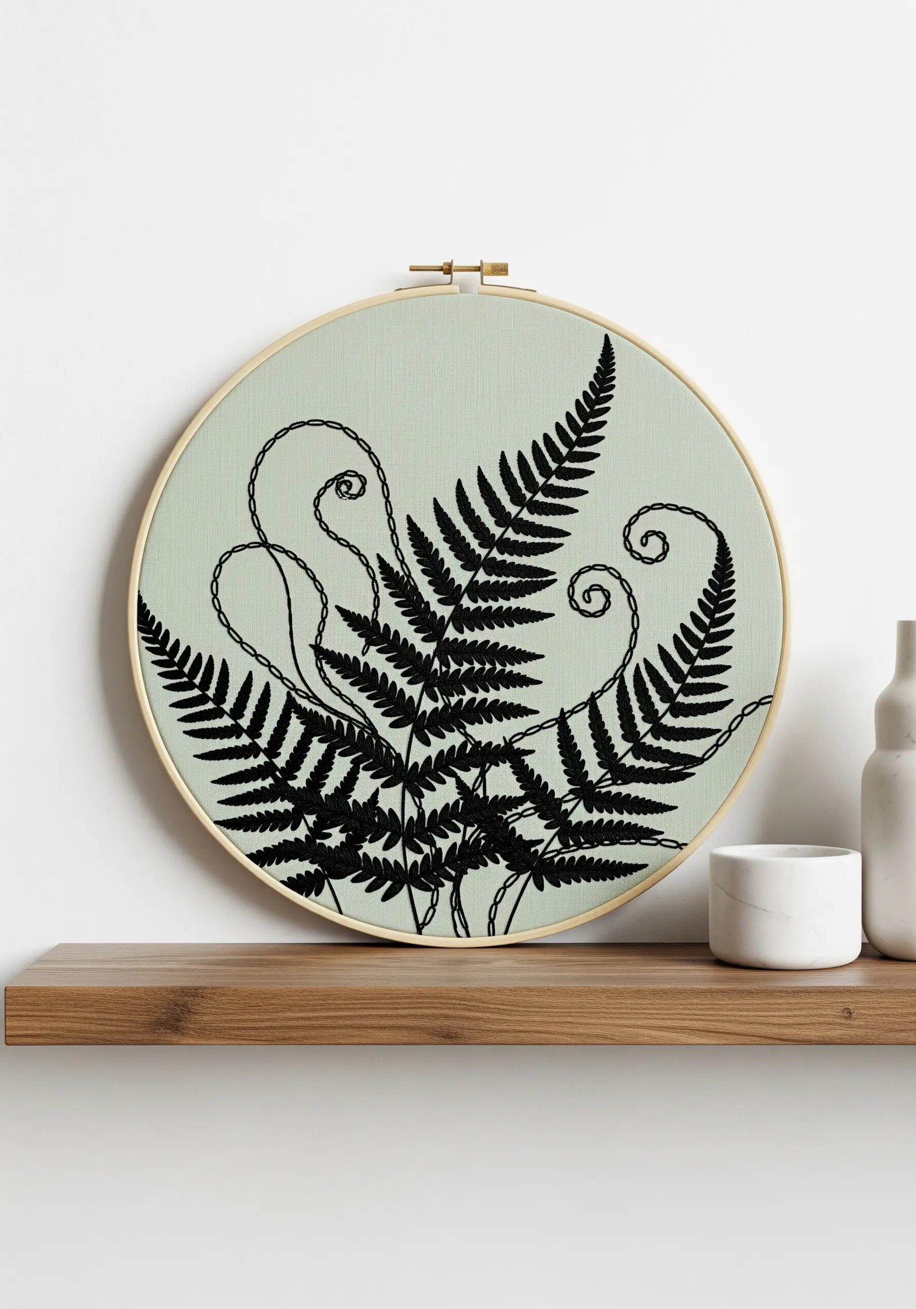 Black fern embroidery combining satin stitch fills and line art stems.