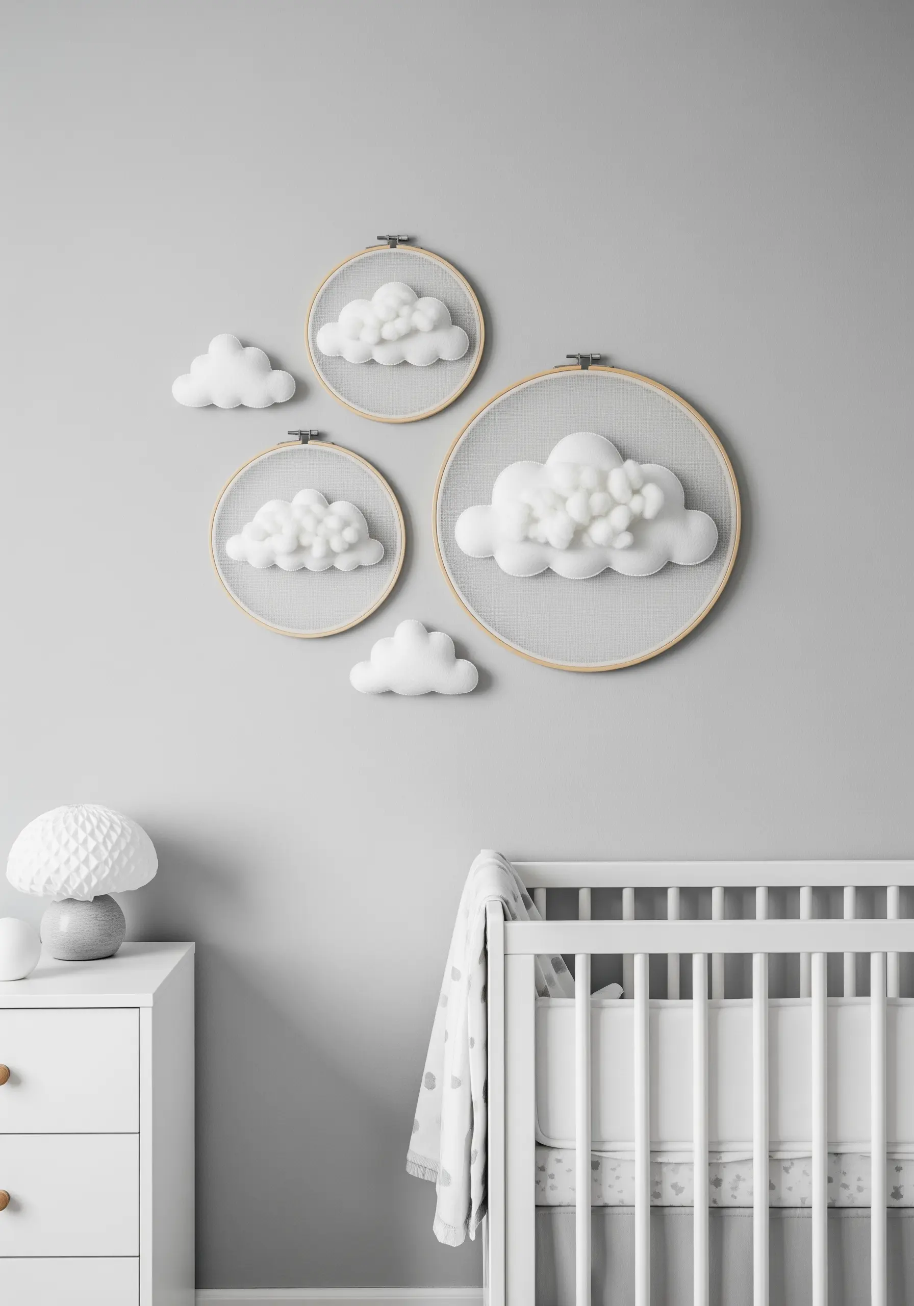A collection of embroidery hoops with fluffy, 3D white clouds for nursery decor.