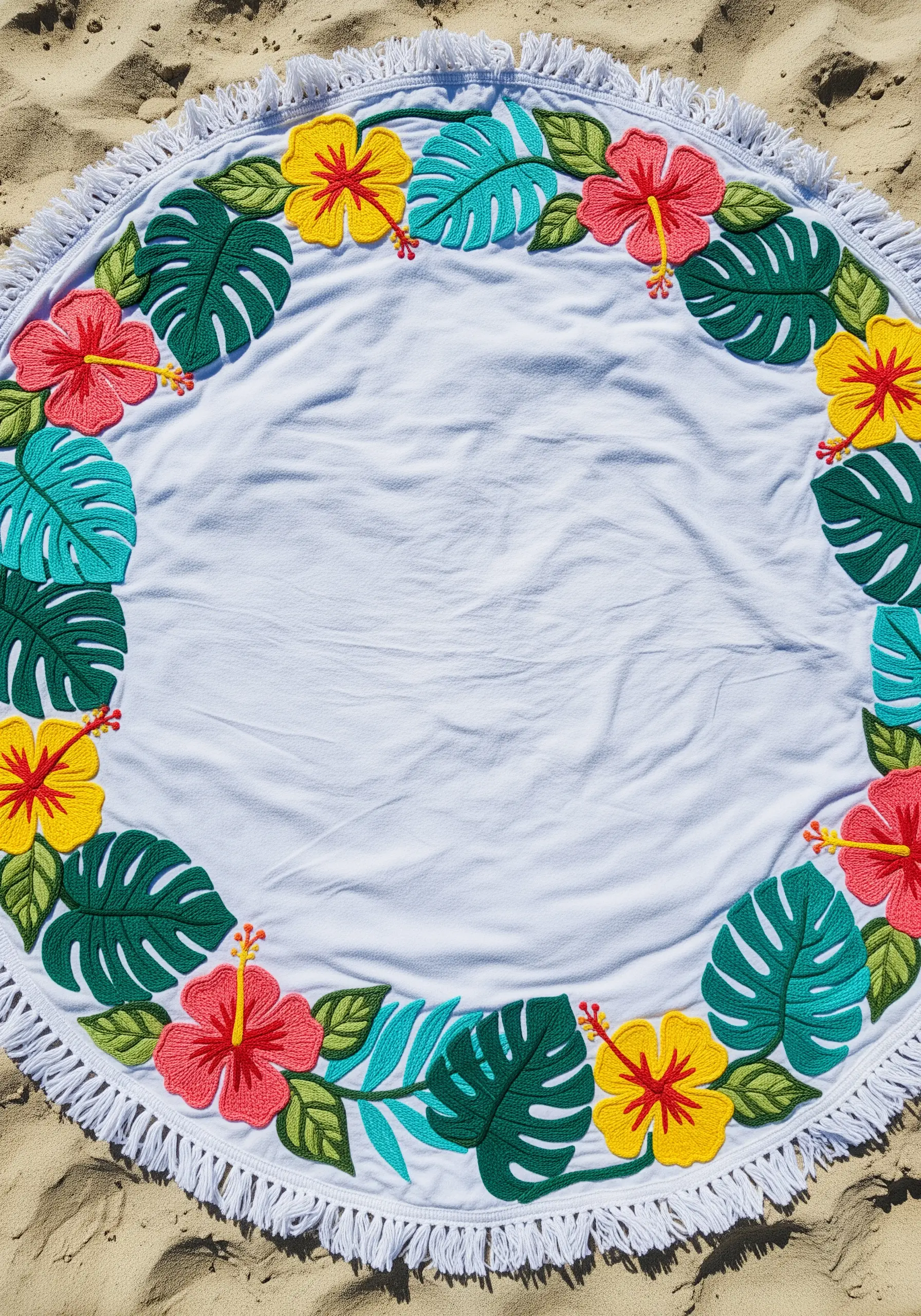 A round beach blanket with a border of colorful felt appliqué leaves and hibiscus flowers.