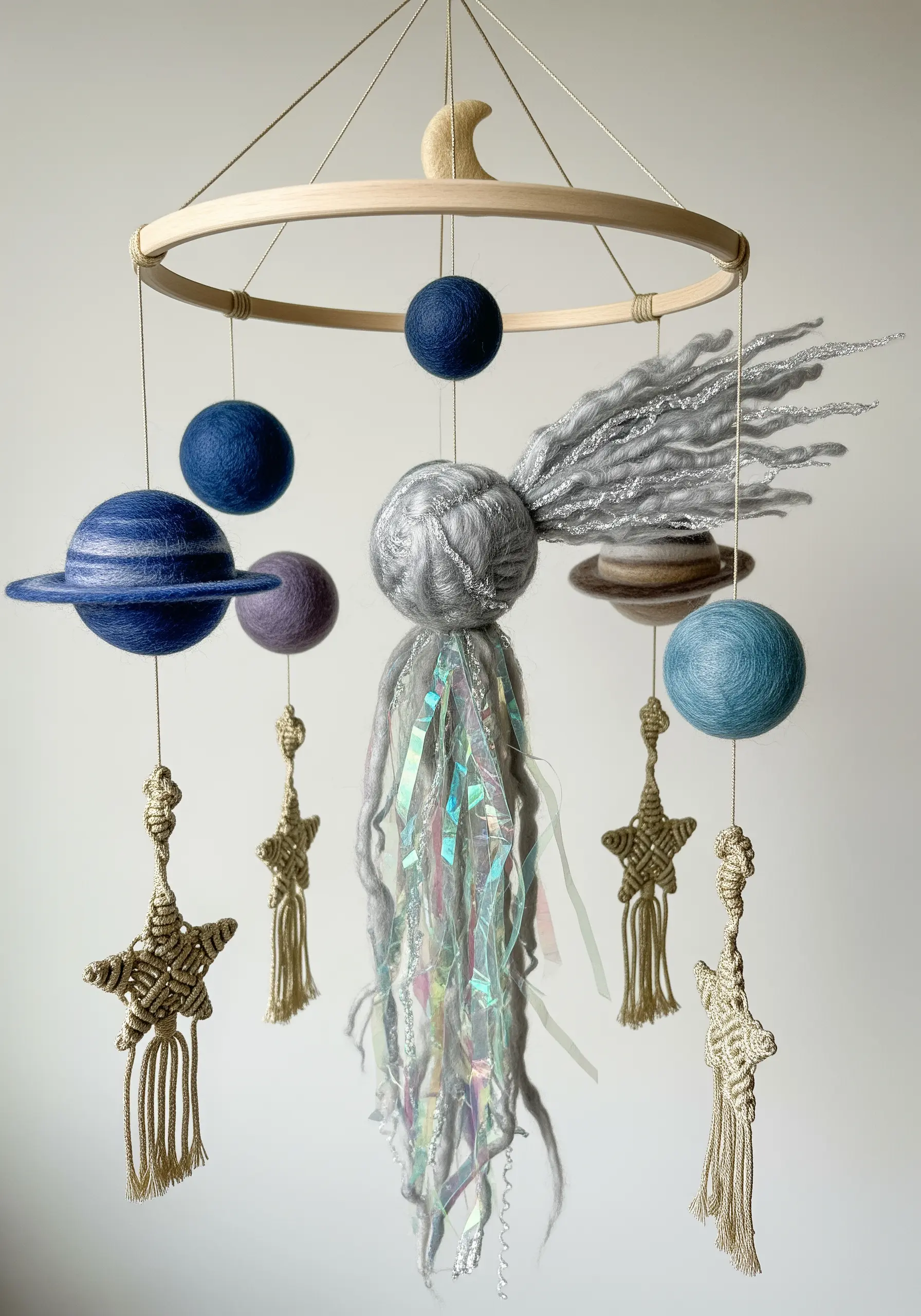 A space-themed nursery mobile with felted planets, a comet with a sparkly tail, and macrame stars.
